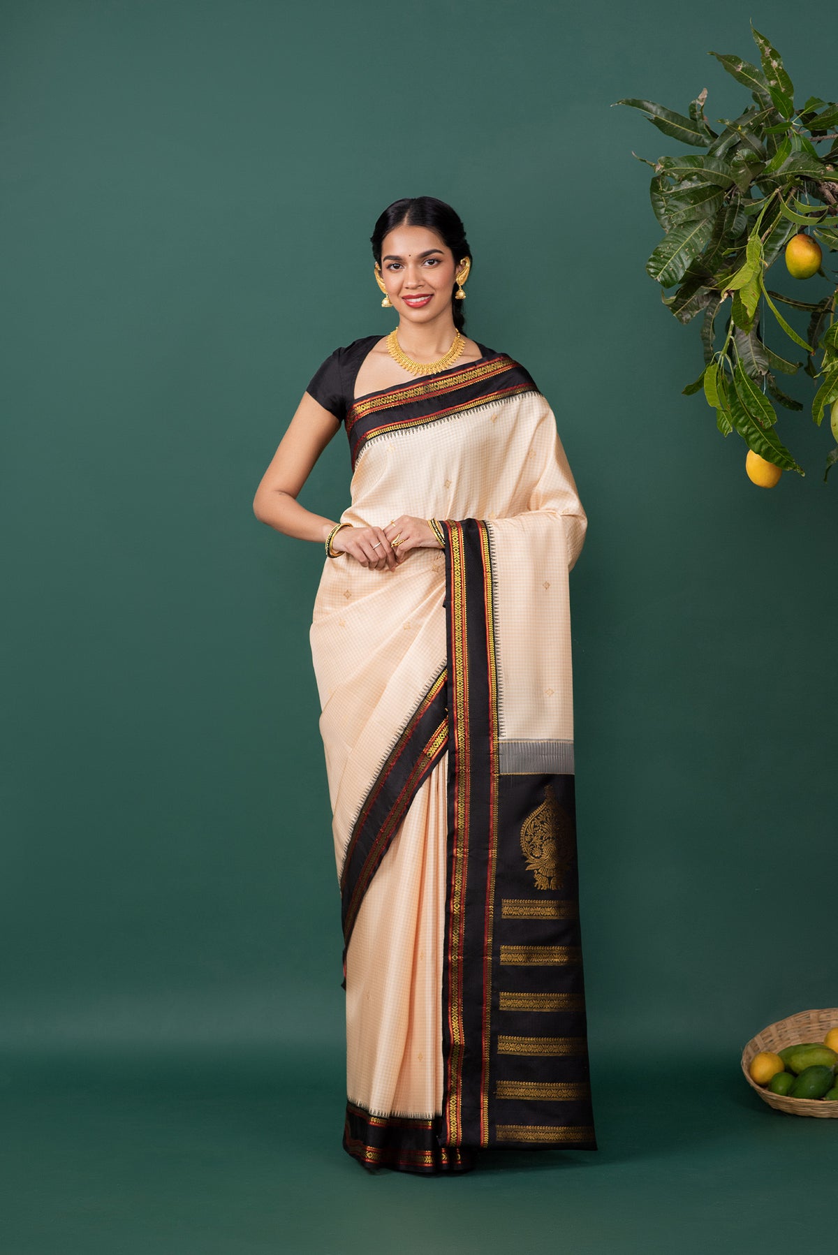 Off White Kanchipuram Silk Saree with Zari Butta on the body and Zari Border displayed on a mannequin