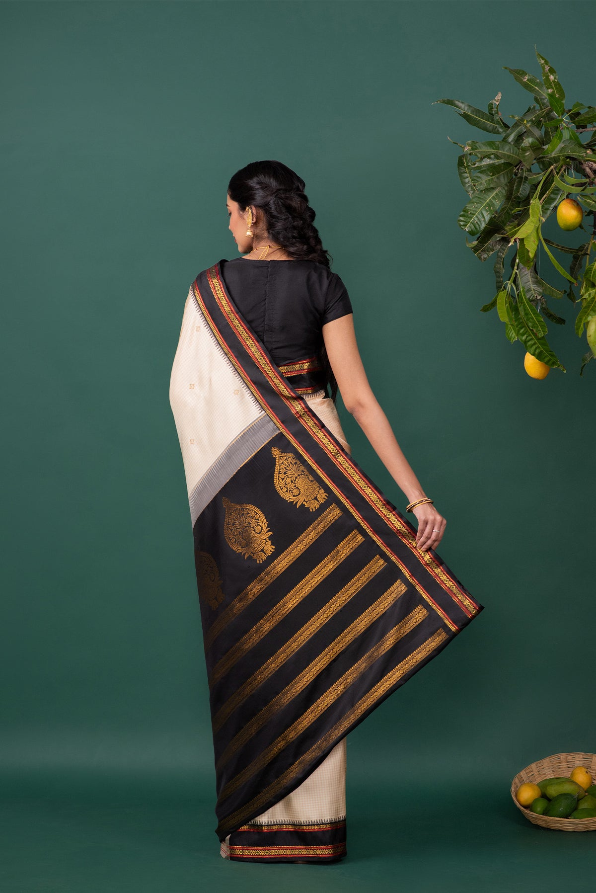 Close up image of the pallu of Off White Kanchipuram Silk Saree with Zari Butta on the body and Zari Border