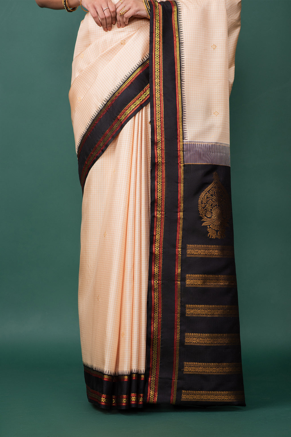 Pleats and pallu of Off White Kanchipuram Silk Saree with Zari Butta on the body and Zari Border