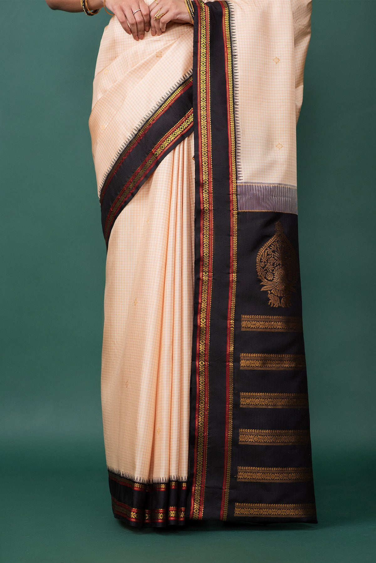 Pleats and pallu of Off White Kanchipuram Silk Saree with Zari Butta on the body and Zari Border