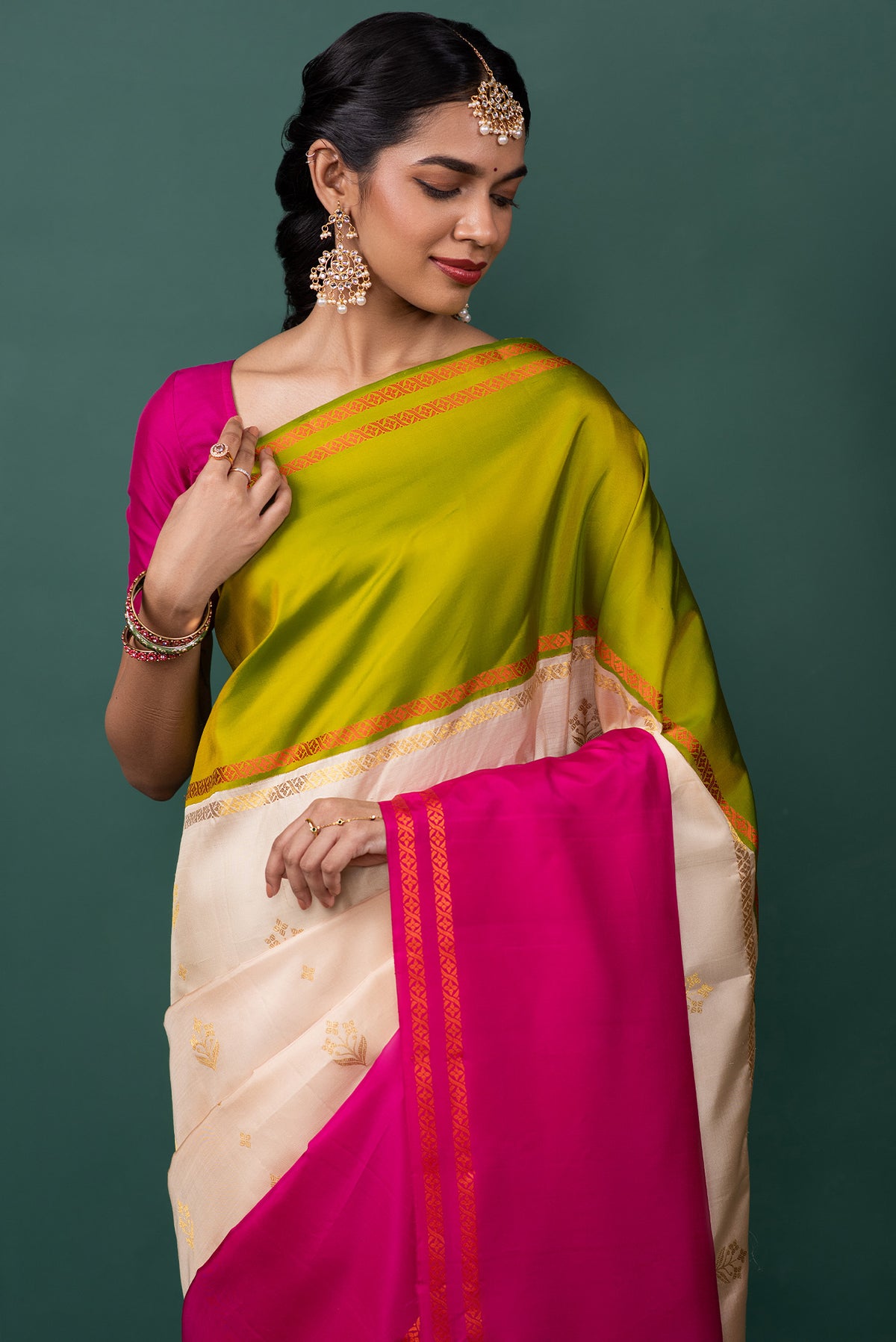 Close up of Multi Color Kanchipuram Silk Saree with Zari Butta on the body and Thread Border displaying folds