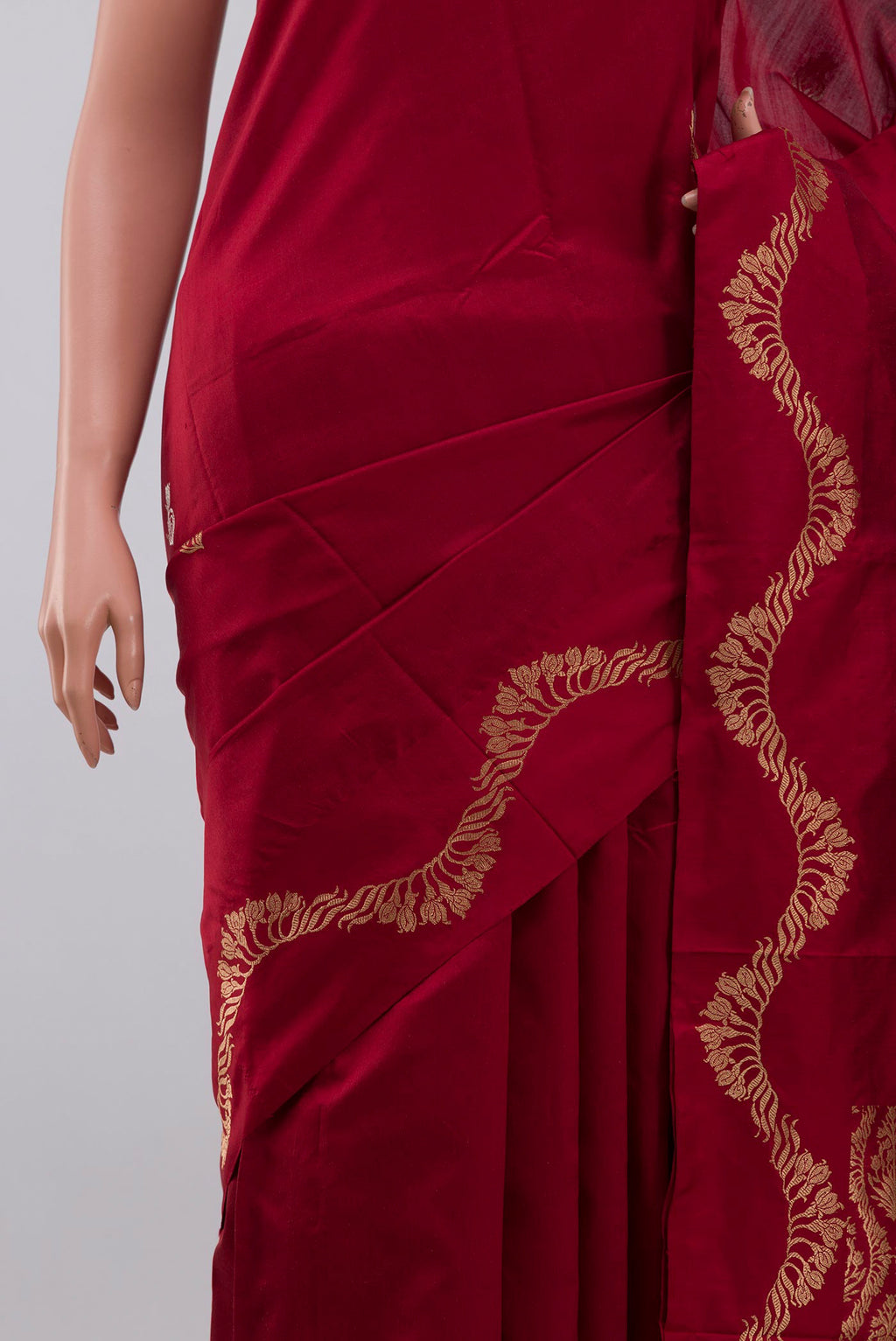 Close up of Maroon Banarasi Katan Silk Saree with Zari Butta on the body and Zari Border displaying folds