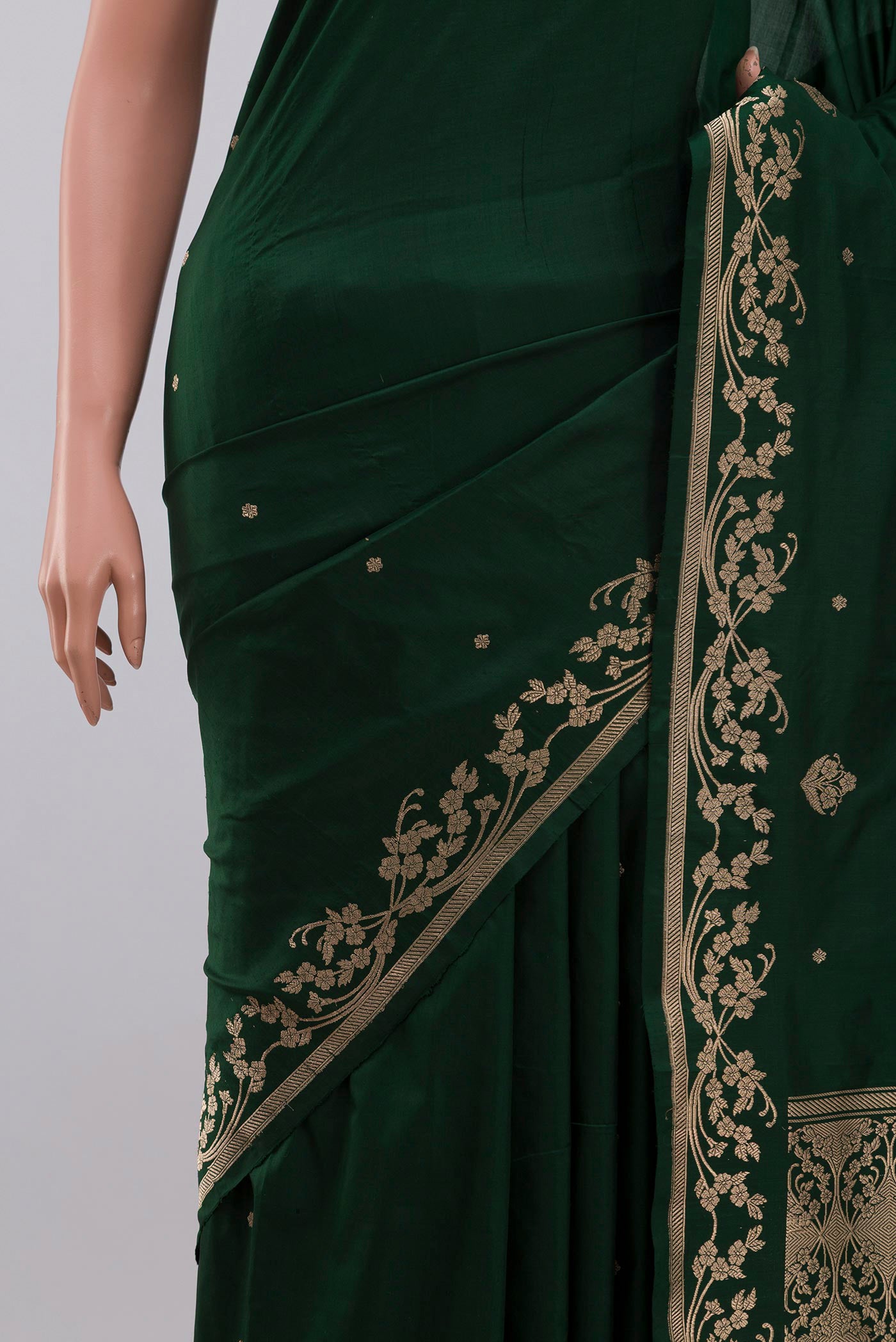 Close up of Green Banarasi Katan Silk Saree with Zari Butta on the body and Zari Border displaying folds