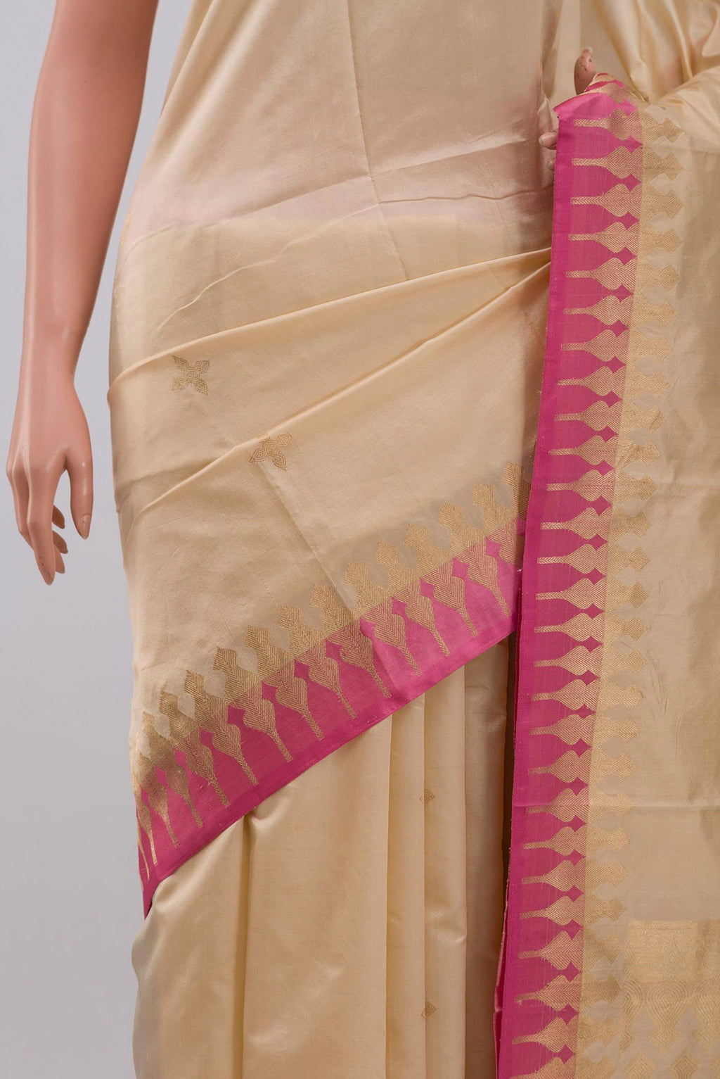Close up of Beige Banarasi Silk Saree with Zari Butta on the body and Zari Border displaying folds