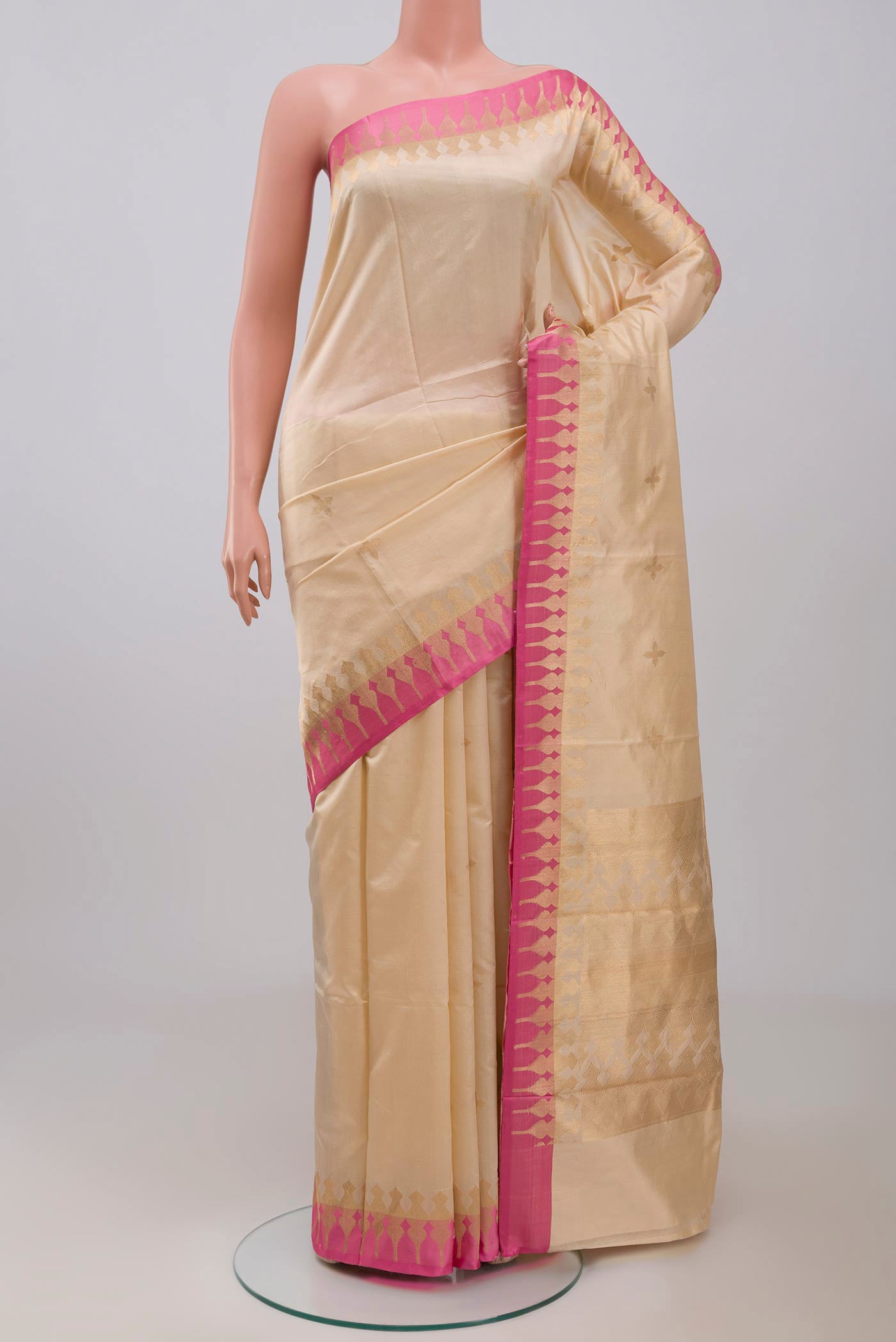 Beige Banarasi Silk Saree with Zari Butta on the body and Zari Border displayed on a mannequin