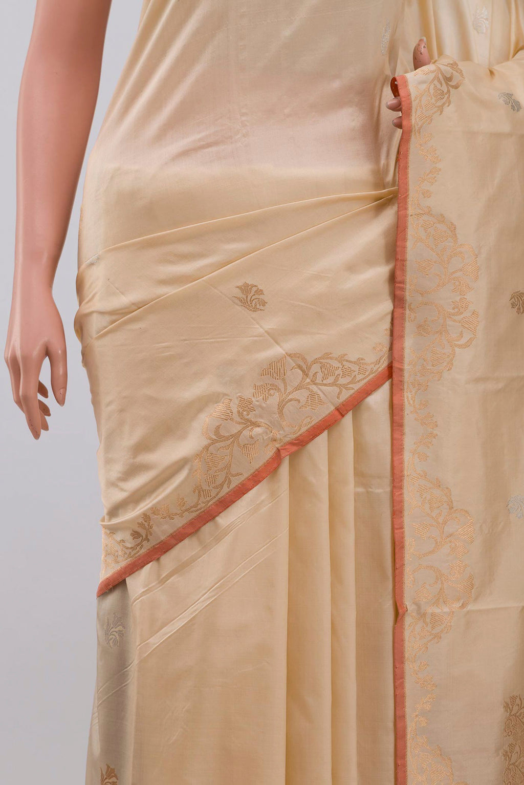Close up of Beige Banarasi Katan Silk Saree with Zari Butta on the body and Zari Border displaying folds