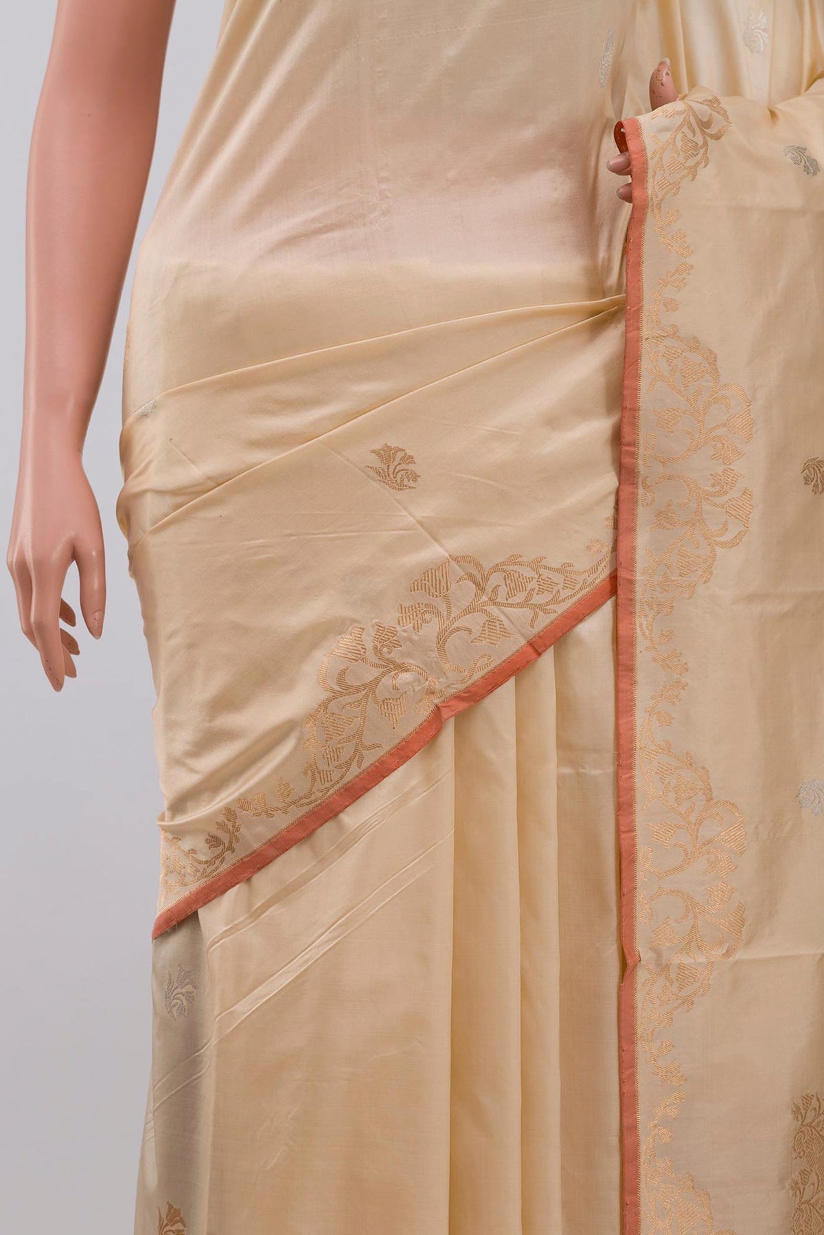 Close up of Beige Banarasi Katan Silk Saree with Zari Butta on the body and Zari Border displaying folds