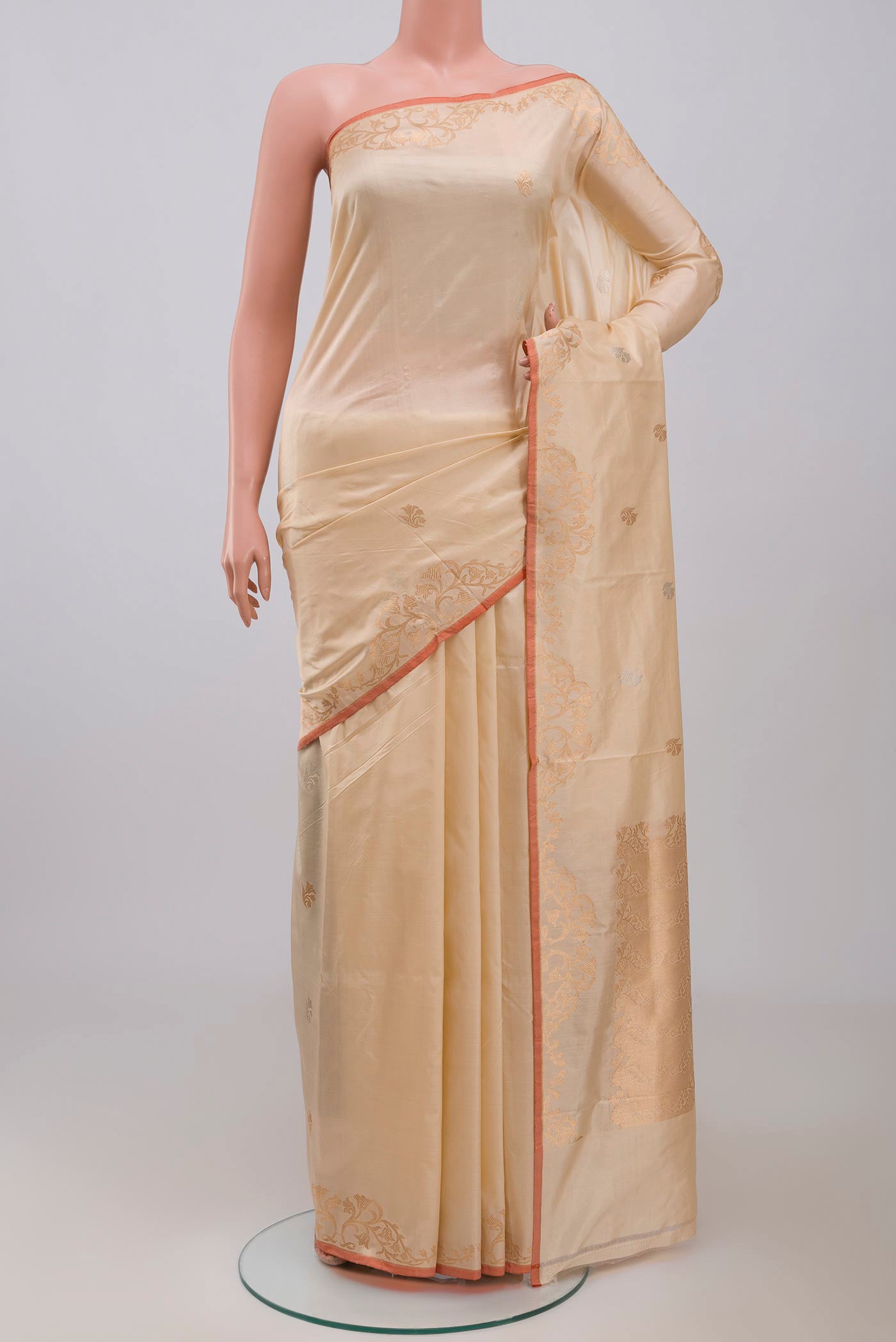 Beige Banarasi Katan Silk Saree with Zari Butta on the body and Zari Border displayed on a mannequin