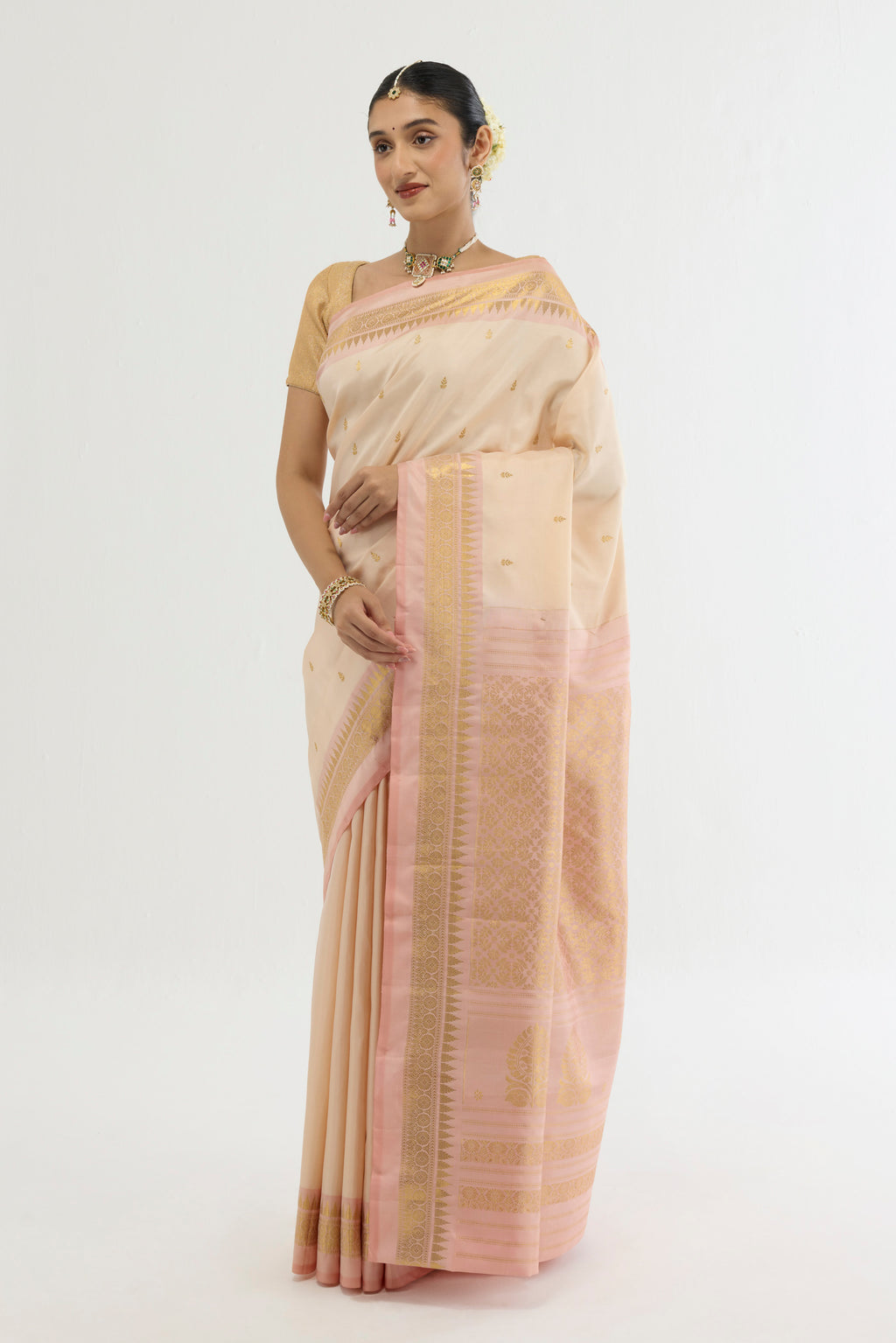 Close up of Cream Kanchipuram Silk Saree with Zari Butta on the body and Zari Border displaying folds