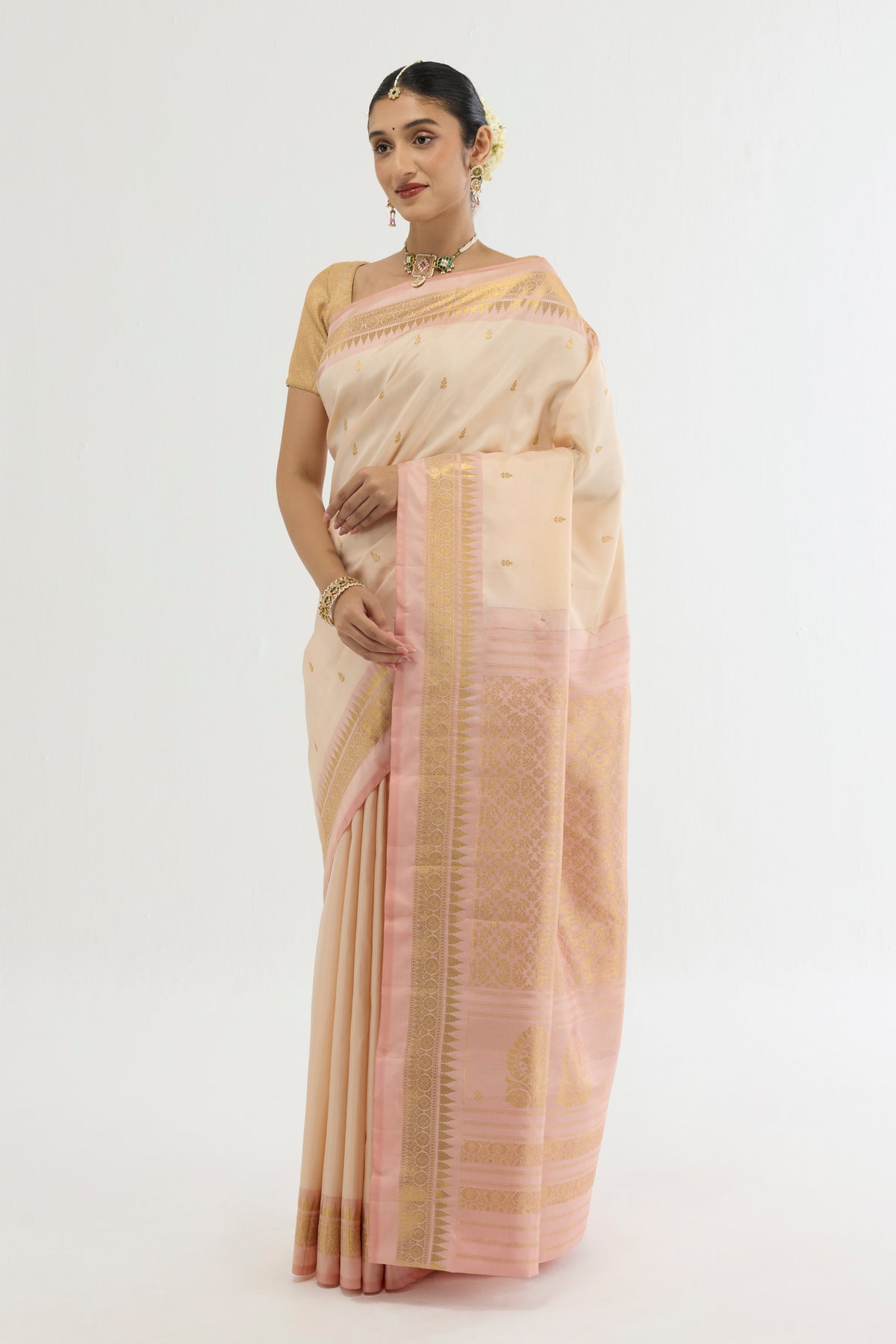Close up of Cream Kanchipuram Silk Saree with Zari Butta on the body and Zari Border displaying folds