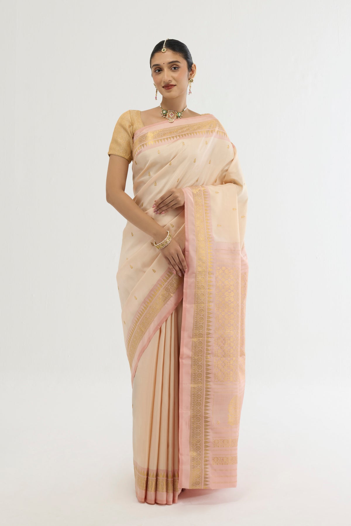 Cream Kanchipuram Silk Saree with Zari Butta on the body and Zari Border displayed on a mannequin