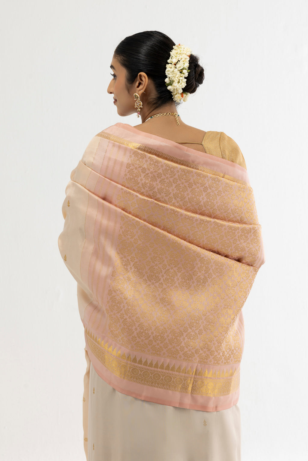 Close up image of the pallu of Cream Kanchipuram Silk Saree with Zari Butta on the body and Zari Border