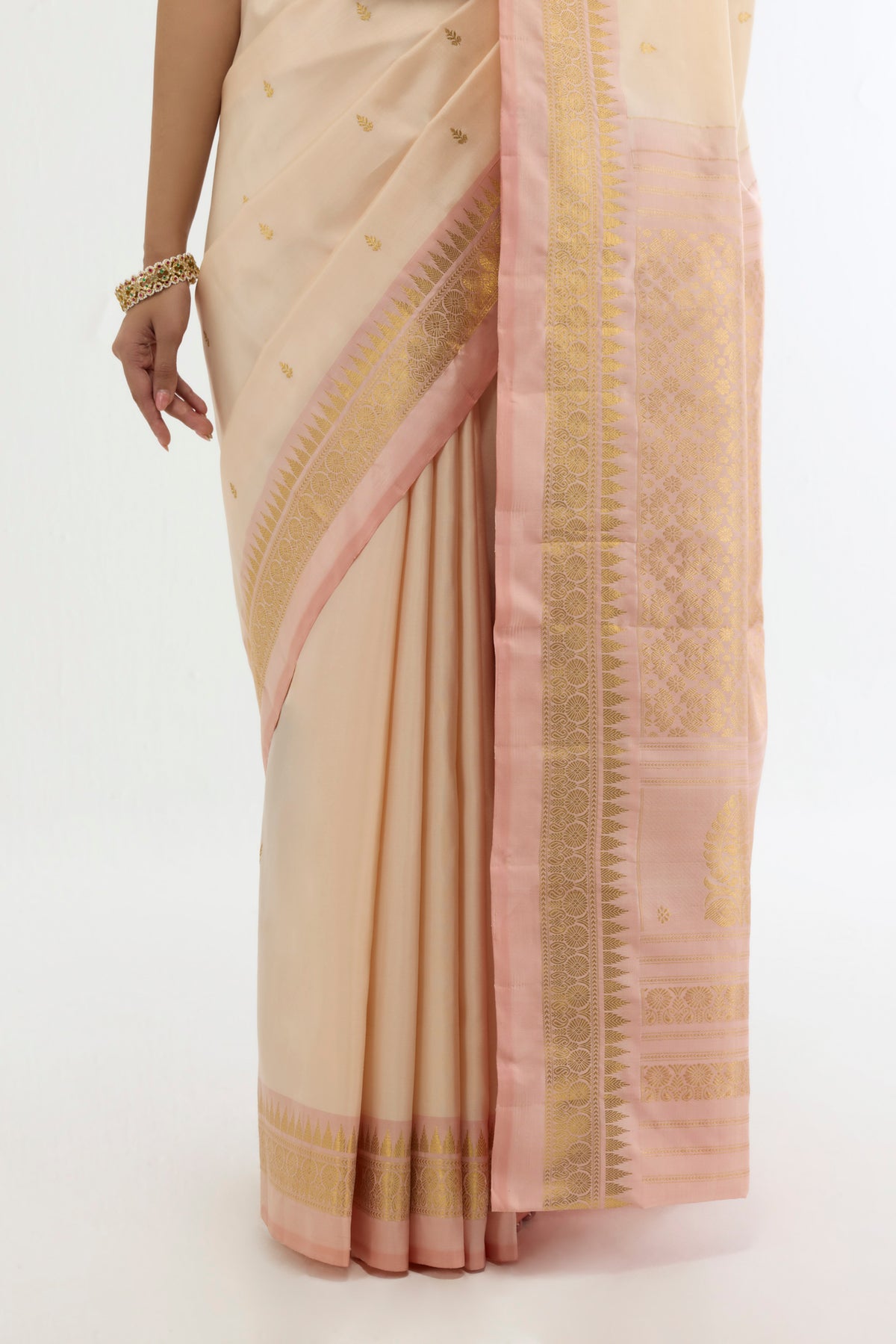 Pleats and pallu of Cream Kanchipuram Silk Saree with Zari Butta on the body and Zari Border