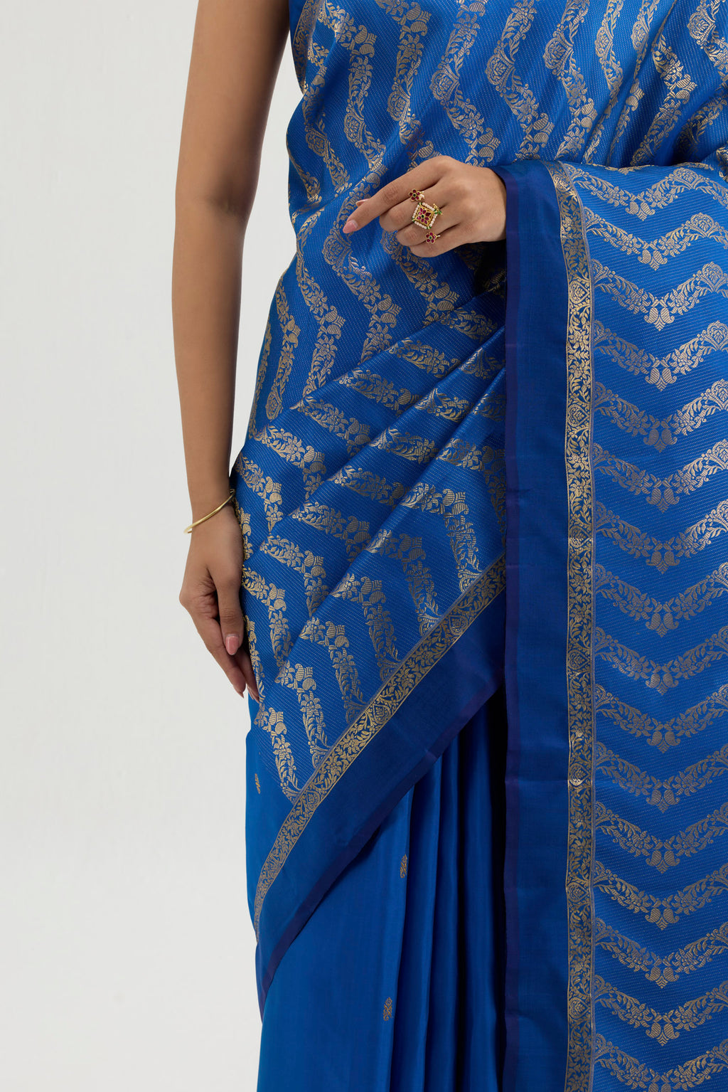 Close up image of the blouse of Blue Kanchipuram Silk Saree with Zari Butta on the body and Zari Border