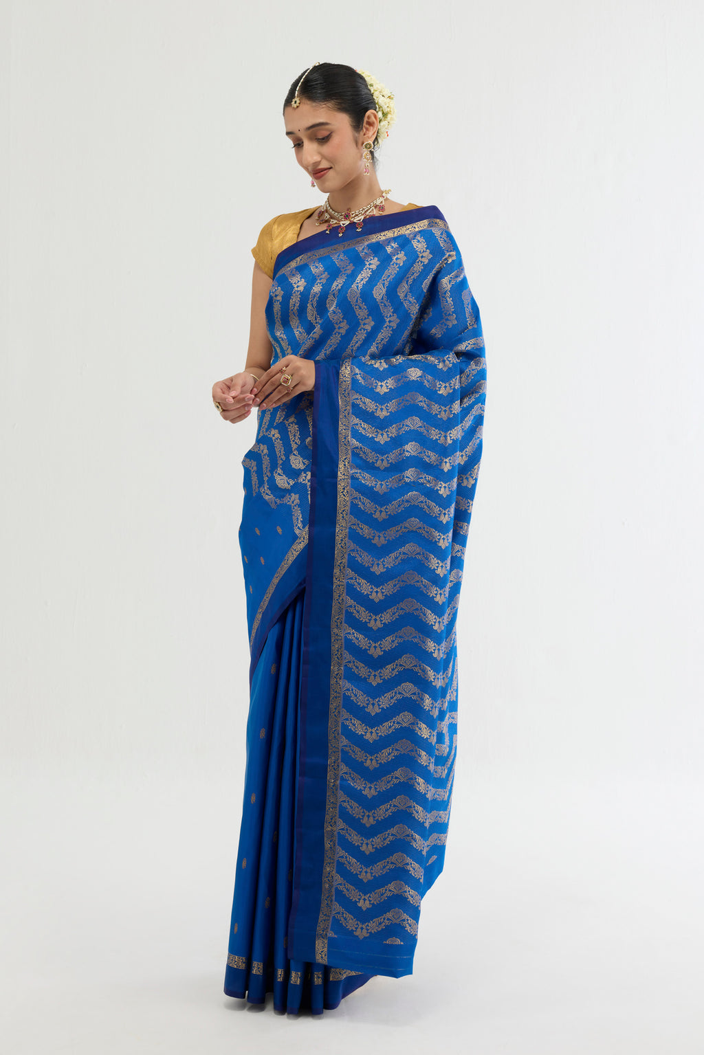 Close up of Blue Kanchipuram Silk Saree with Zari Butta on the body and Zari Border displaying folds