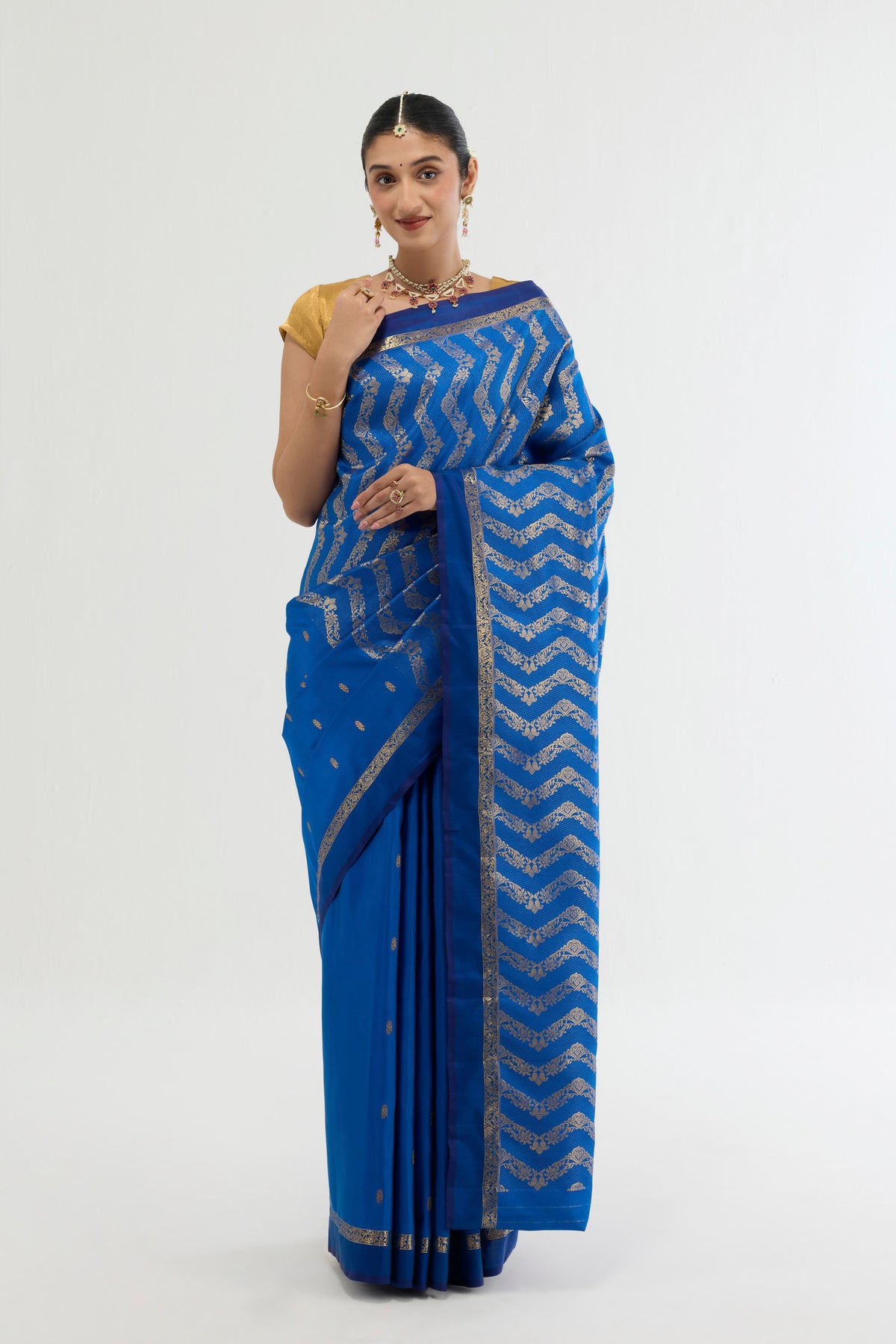 Blue Kanchipuram Silk Saree with Zari Butta on the body and Zari Border displayed on a mannequin