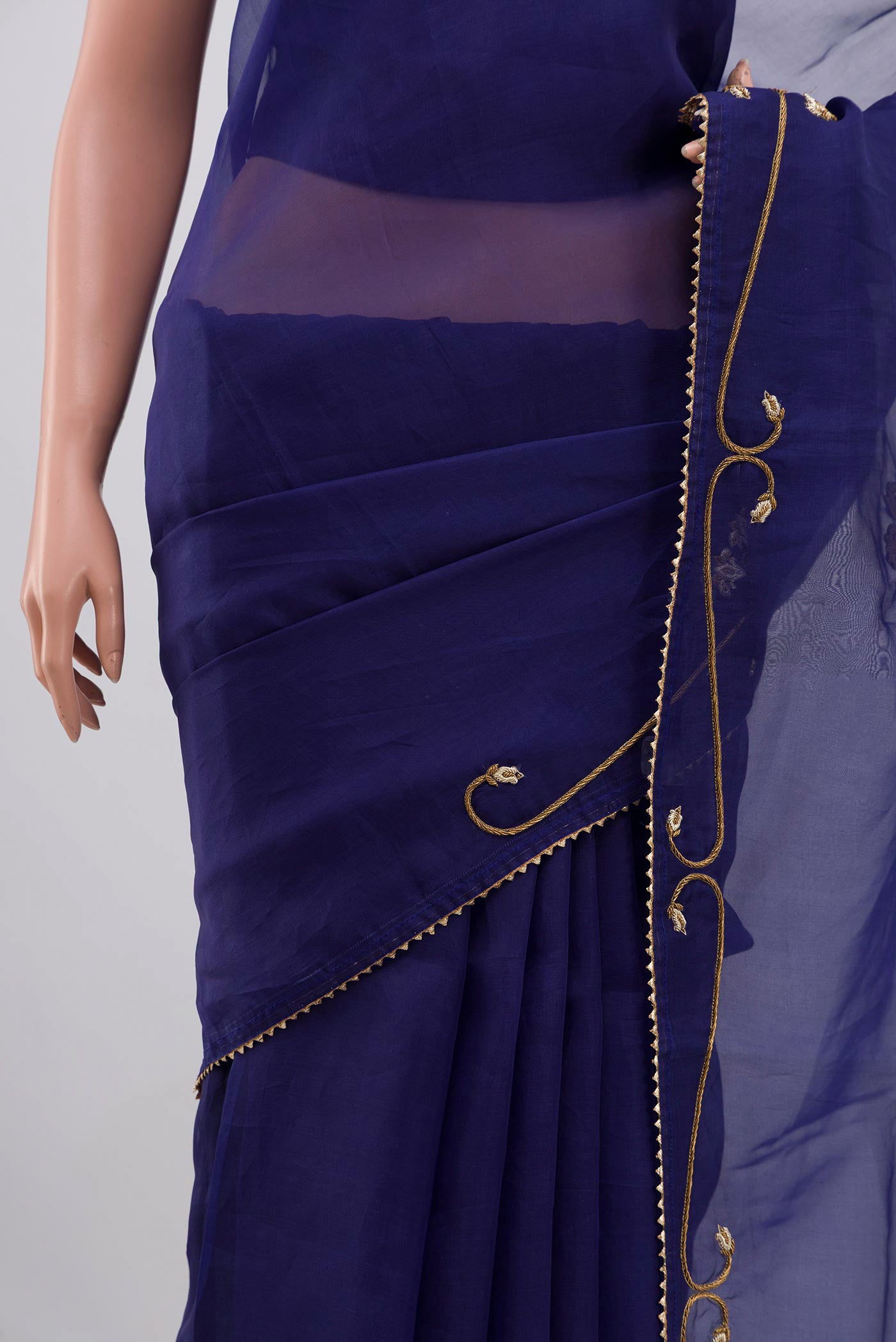 Close up of Blue Organza Silk Saree with Embroidery on the body and Embroidery Border displaying folds