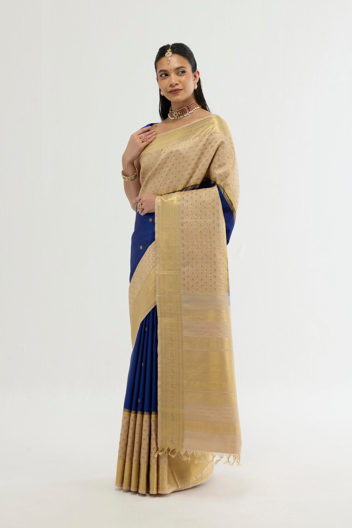 Close up of Multi Color Kanchipuram Silk Saree with Zari And Thread Butta on the body and Zari Border displaying folds