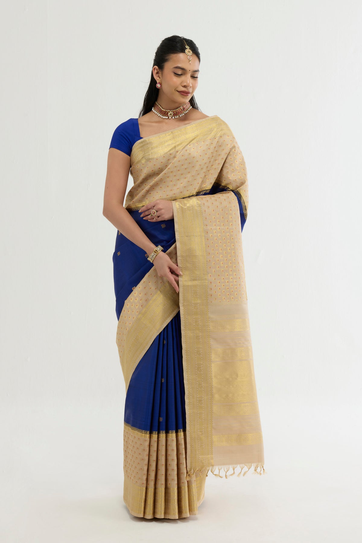 Multi Color Kanchipuram Silk Saree with Zari And Thread Butta on the body and Zari Border displayed on a mannequin