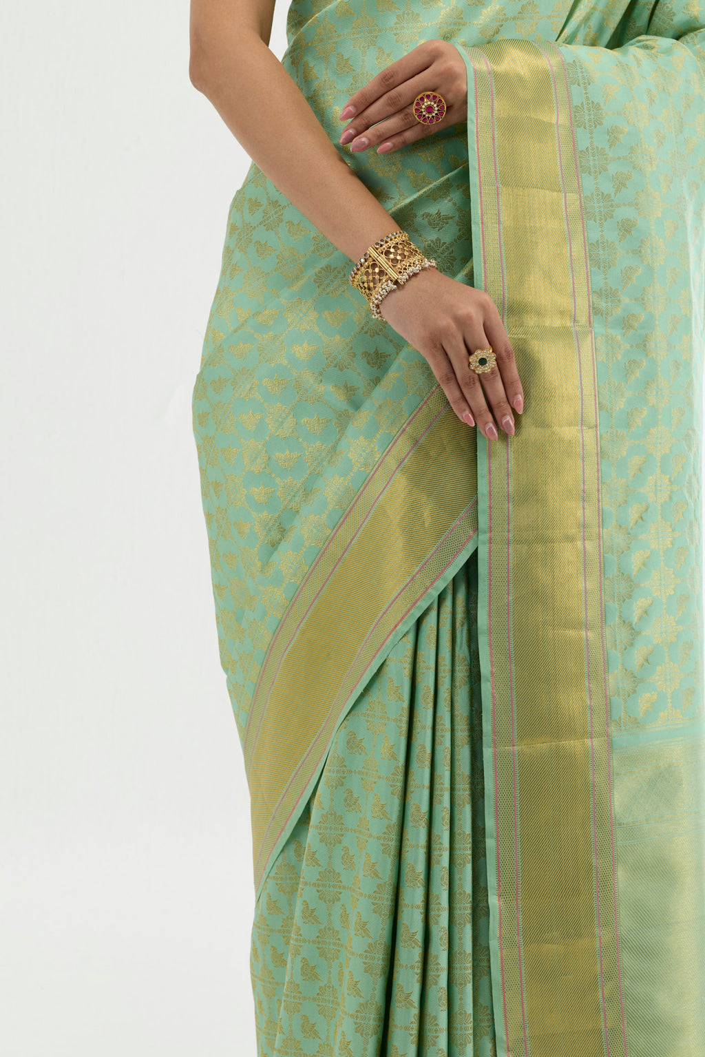 Close up image of the blouse of Green Kanchipuram Silk Saree with Zari Brocade on the body and Zari Border