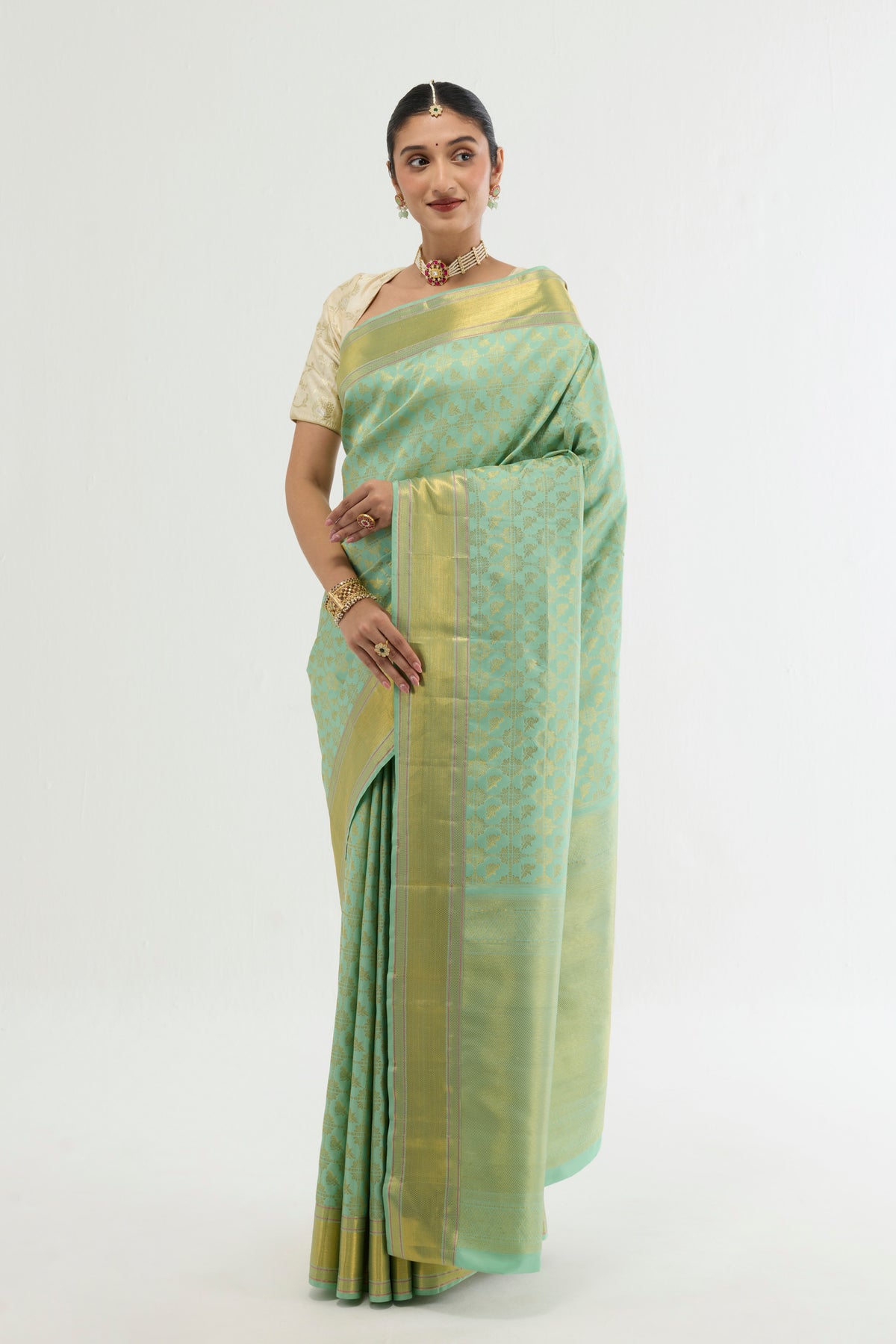 Close up of Green Kanchipuram Silk Saree with Zari Brocade on the body and Zari Border displaying folds