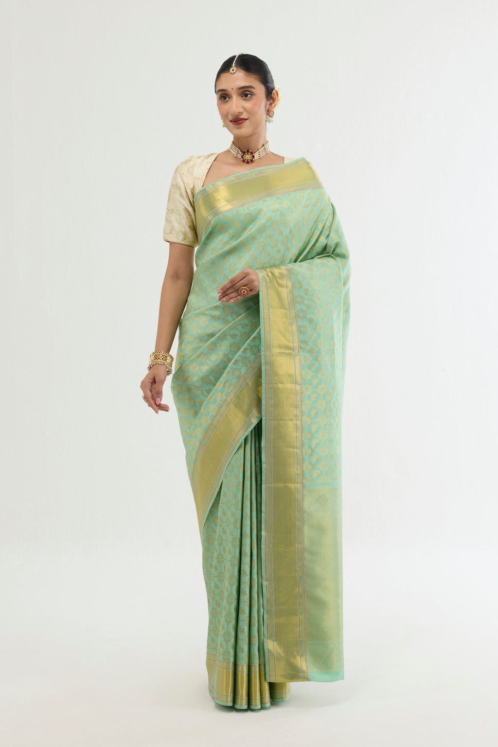 Green Kanchipuram Silk Saree with Zari Brocade on the body and Zari Border displayed on a mannequin