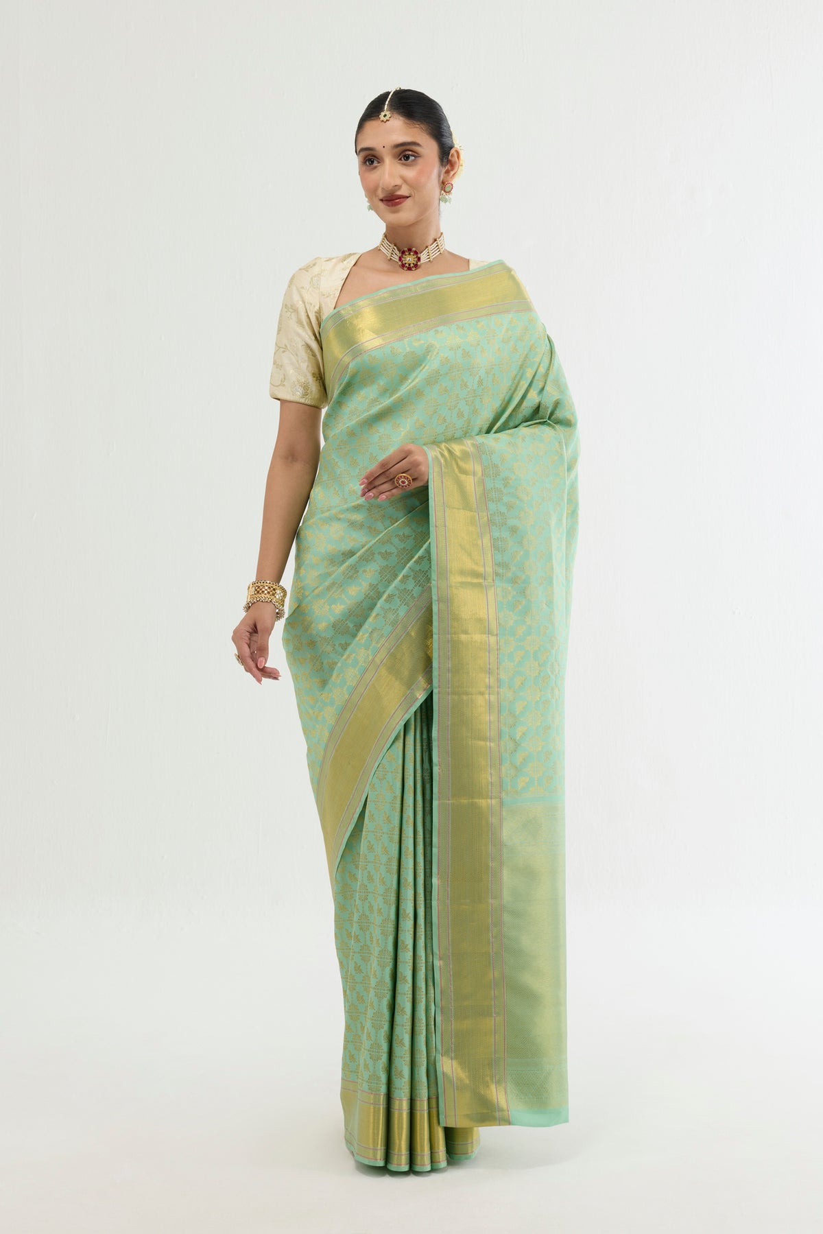 Green Kanchipuram Silk Saree with Zari Brocade on the body and Zari Border displayed on a mannequin