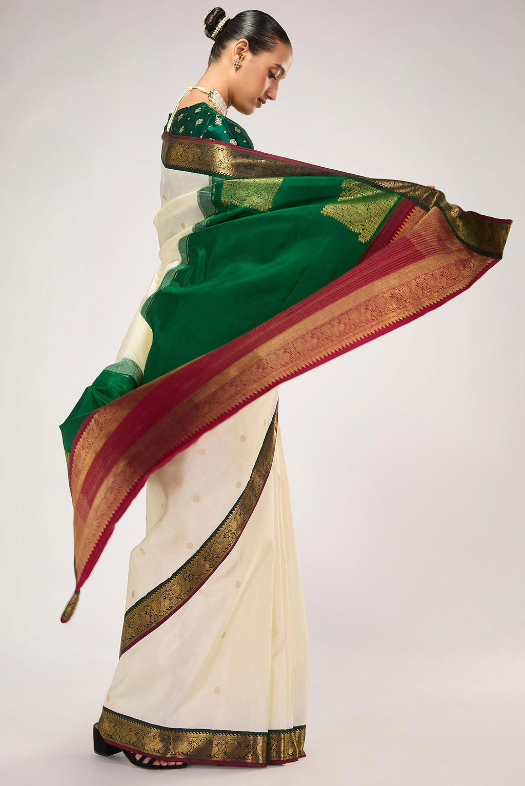 Close up image of the blouse of Off White Kanchipuram Silk Saree with Zari Butta on the body and Zari Border
