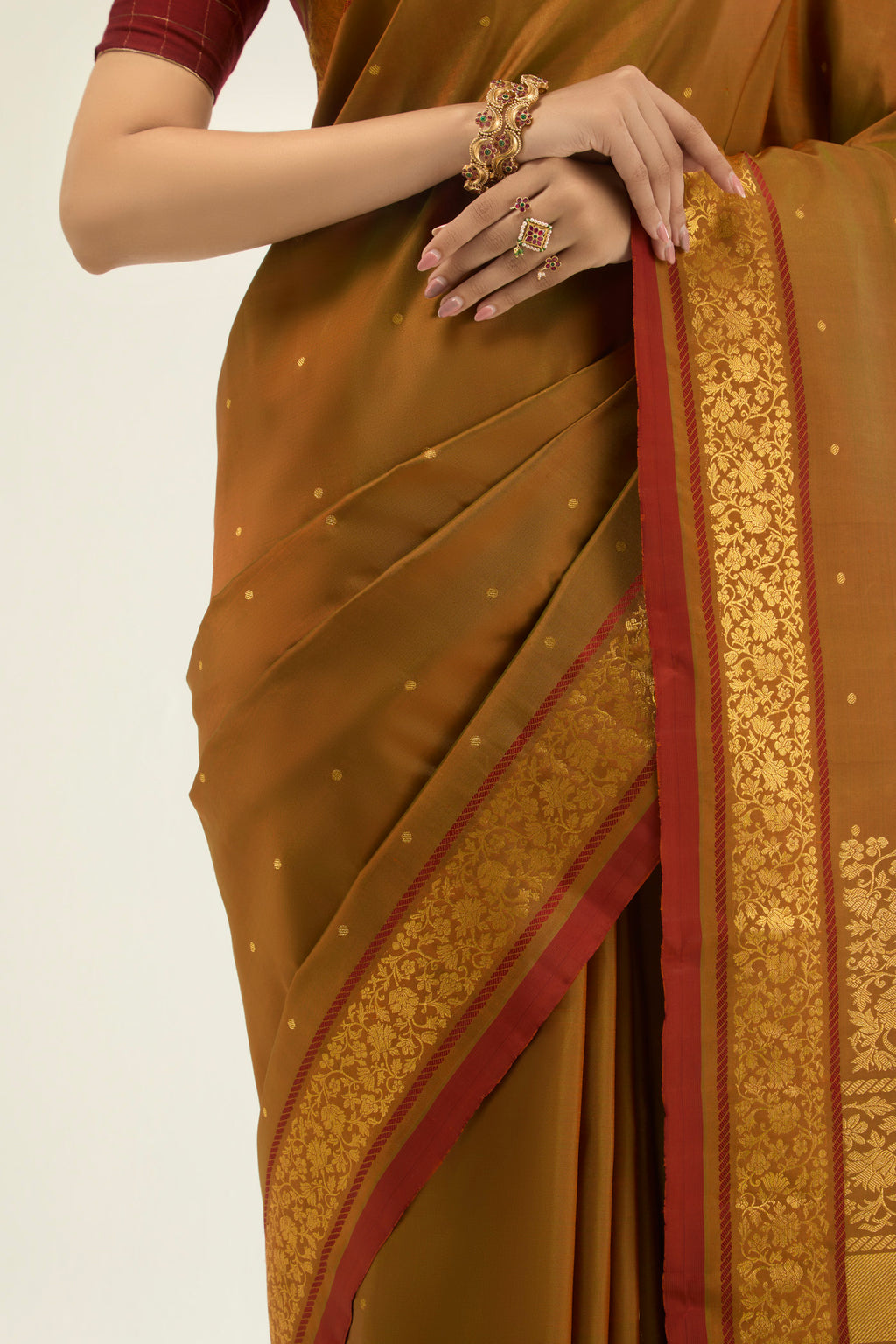 Close up image of the blouse of Mustard with Green Color Kanchipuram Silk Saree with Zari Butta on the body and Zari Border