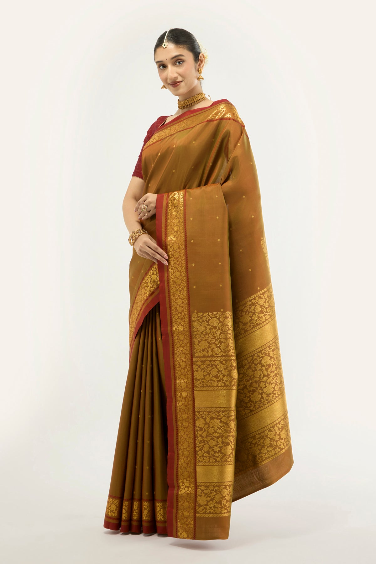 Close up of Mustard with Green Color Kanchipuram Silk Saree with Zari Butta on the body and Zari Border displaying folds