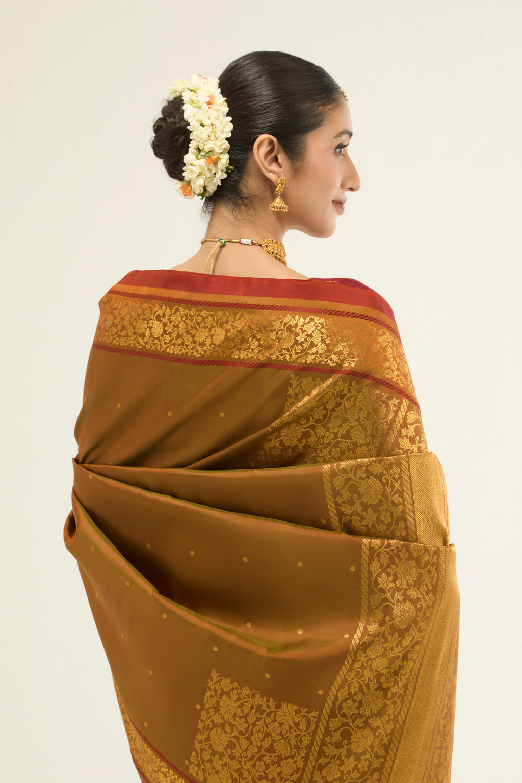 Close up image of the pallu of Mustard with Green Color Kanchipuram Silk Saree with Zari Butta on the body and Zari Border