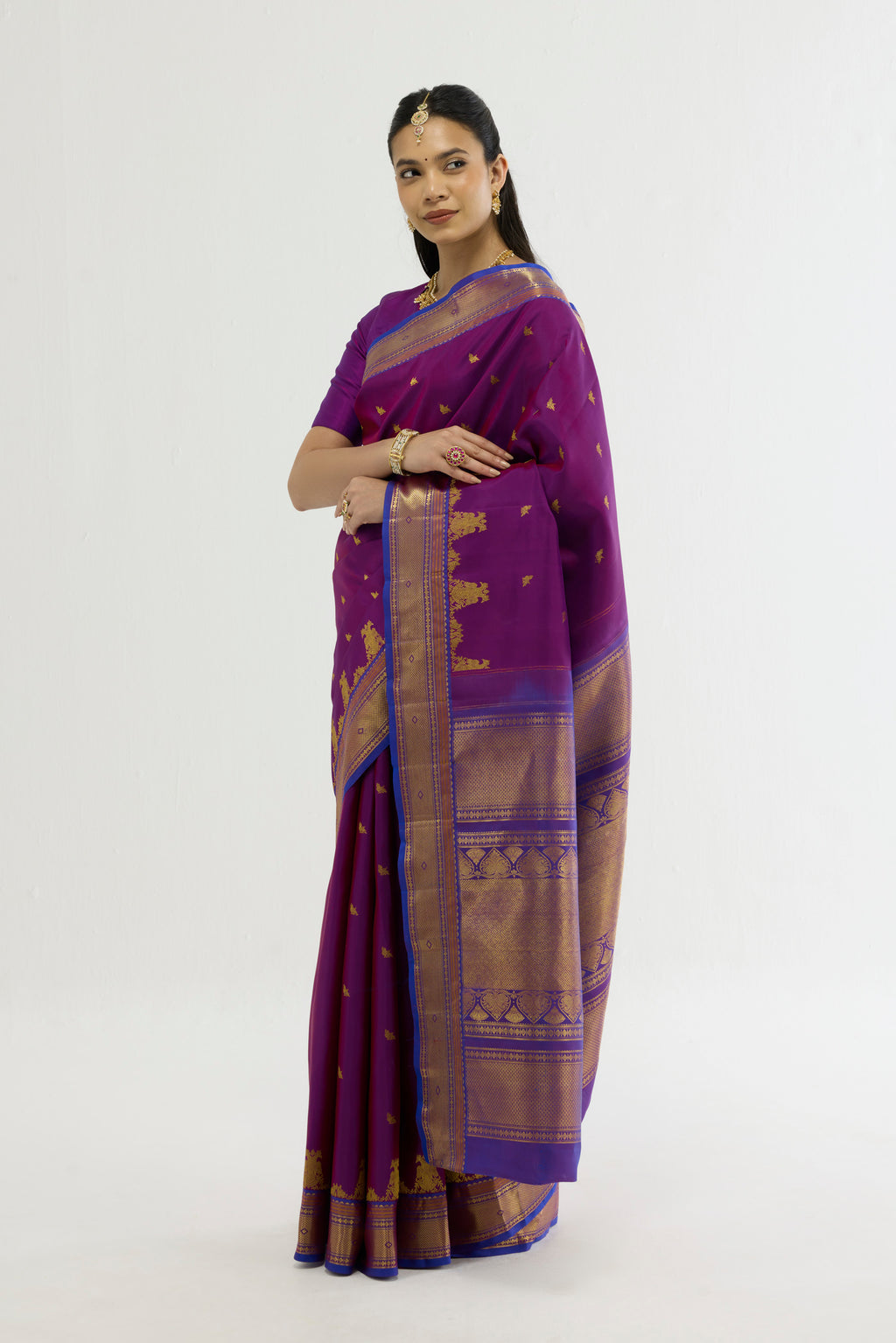 Close up of Purple Kanchipuram Silk Saree with Zari Butta on the body and Zari Border displaying folds