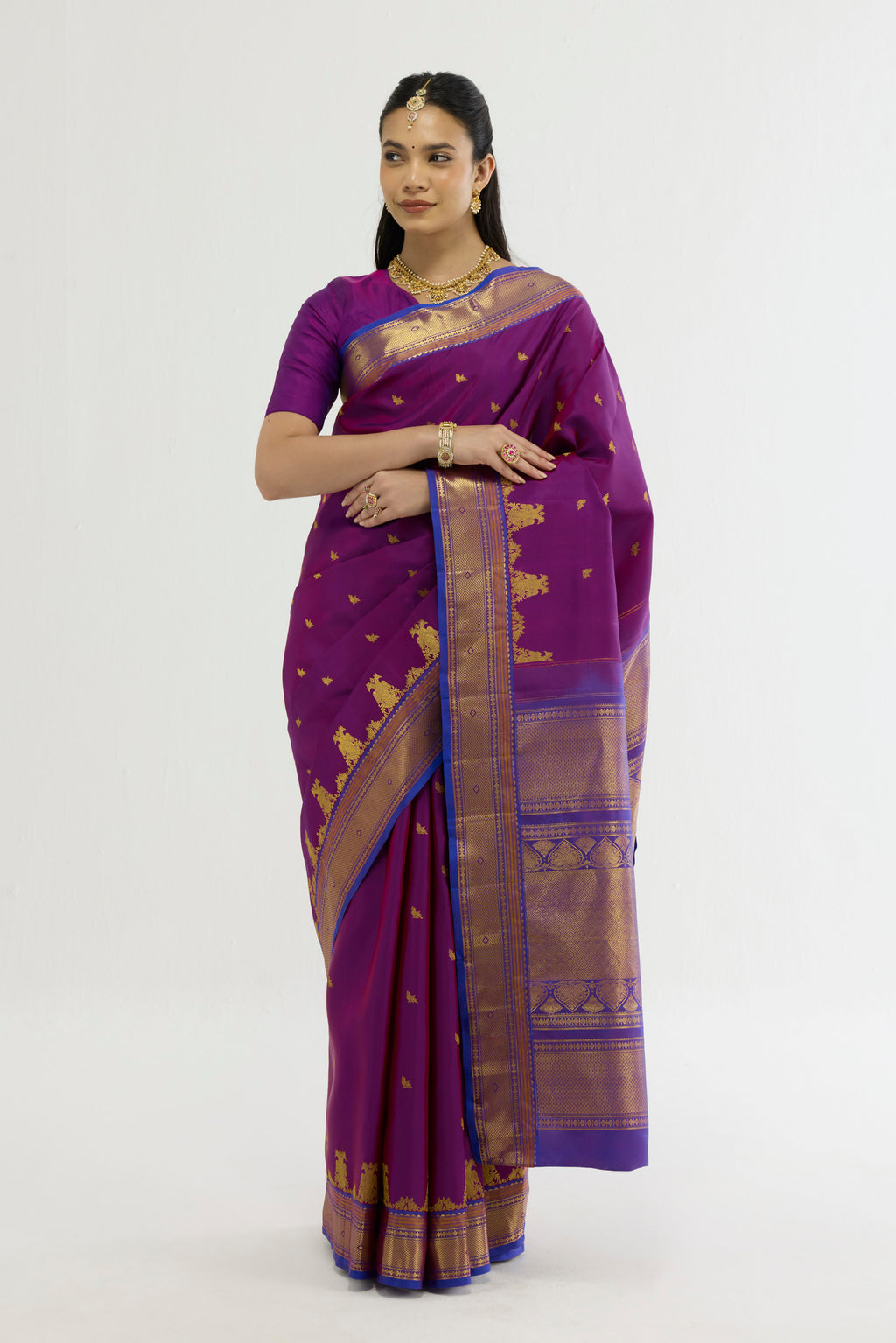 Purple Kanchipuram Silk Saree with Zari Butta on the body and Zari Border displayed on a mannequin