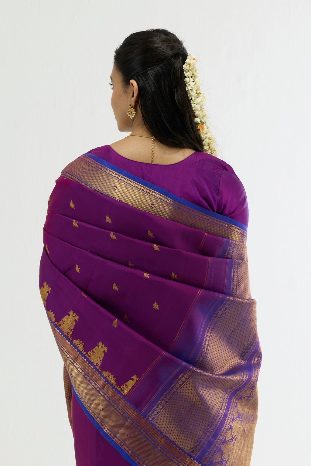 Close up image of the pallu of Purple Kanchipuram Silk Saree with Zari Butta on the body and Zari Border