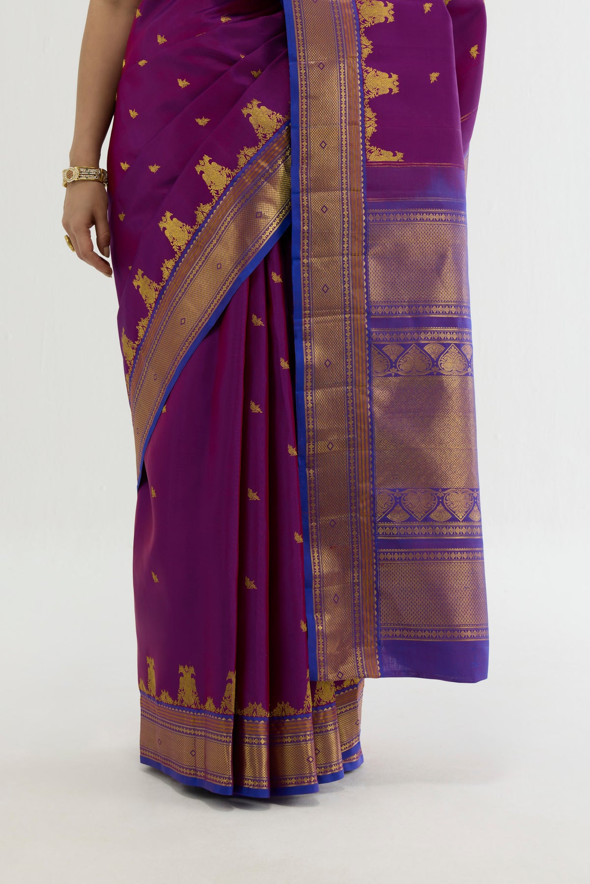 Pleats and pallu of Purple Kanchipuram Silk Saree with Zari Butta on the body and Zari Border