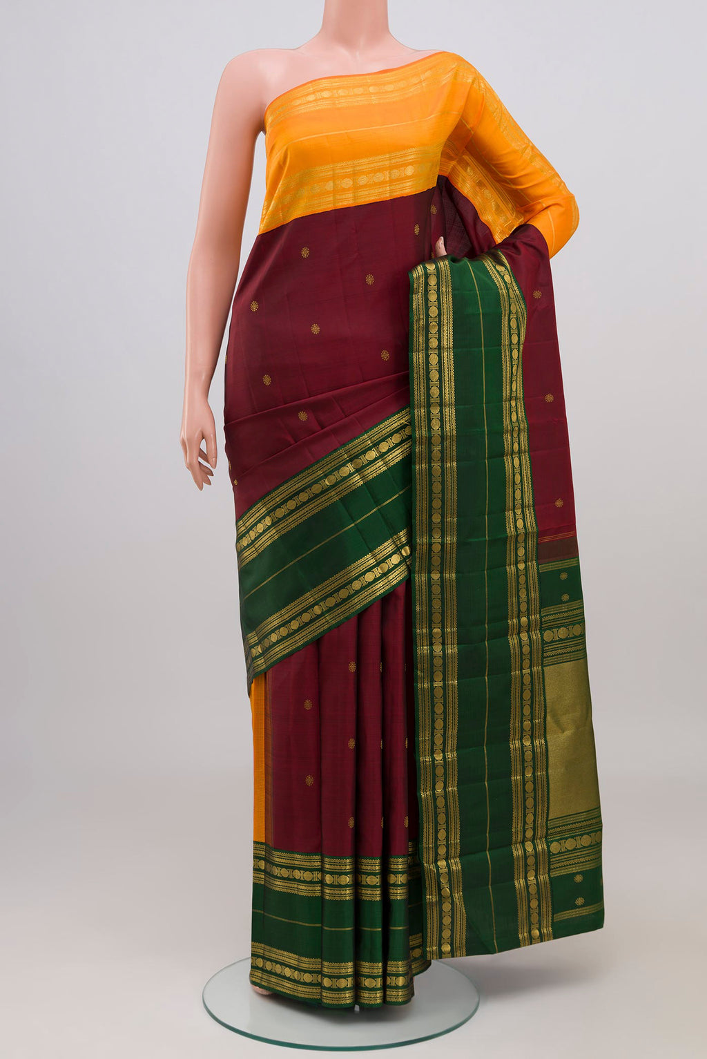 Maroon Kanchipuram Silk Saree with Zari Butta on the body and Ganga Jamuna Border displayed on a mannequin