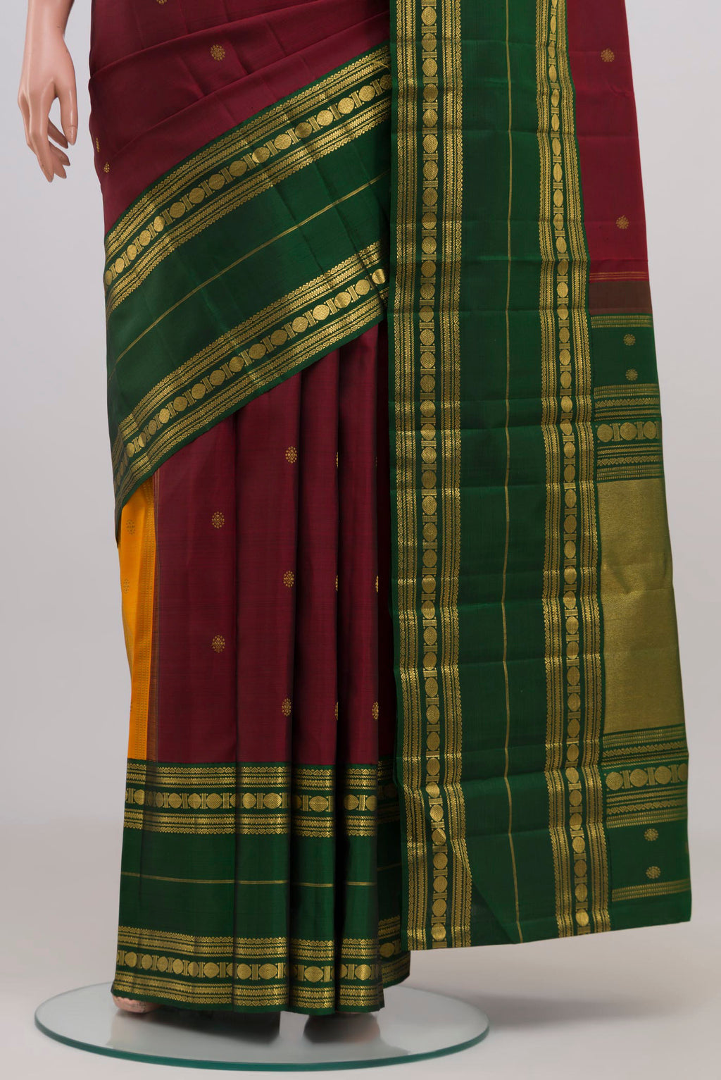 Pleats and pallu of Maroon Kanchipuram Silk Saree with Zari Butta on the body and Ganga Jamuna Border