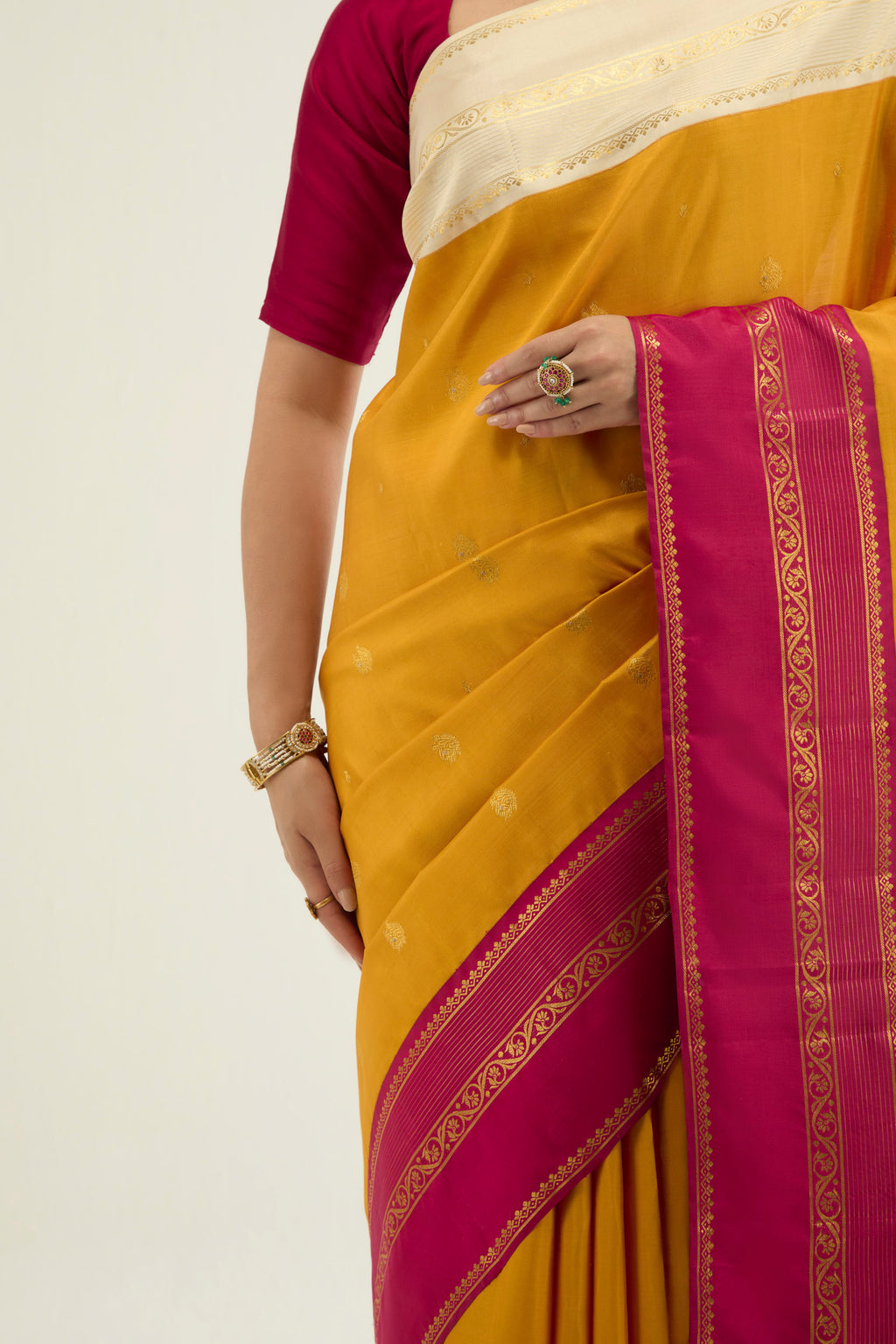 Close up image of the blouse of Yellow Kanchipuram Silk Saree with Zari Butta on the body and Ganga Jamuna Border