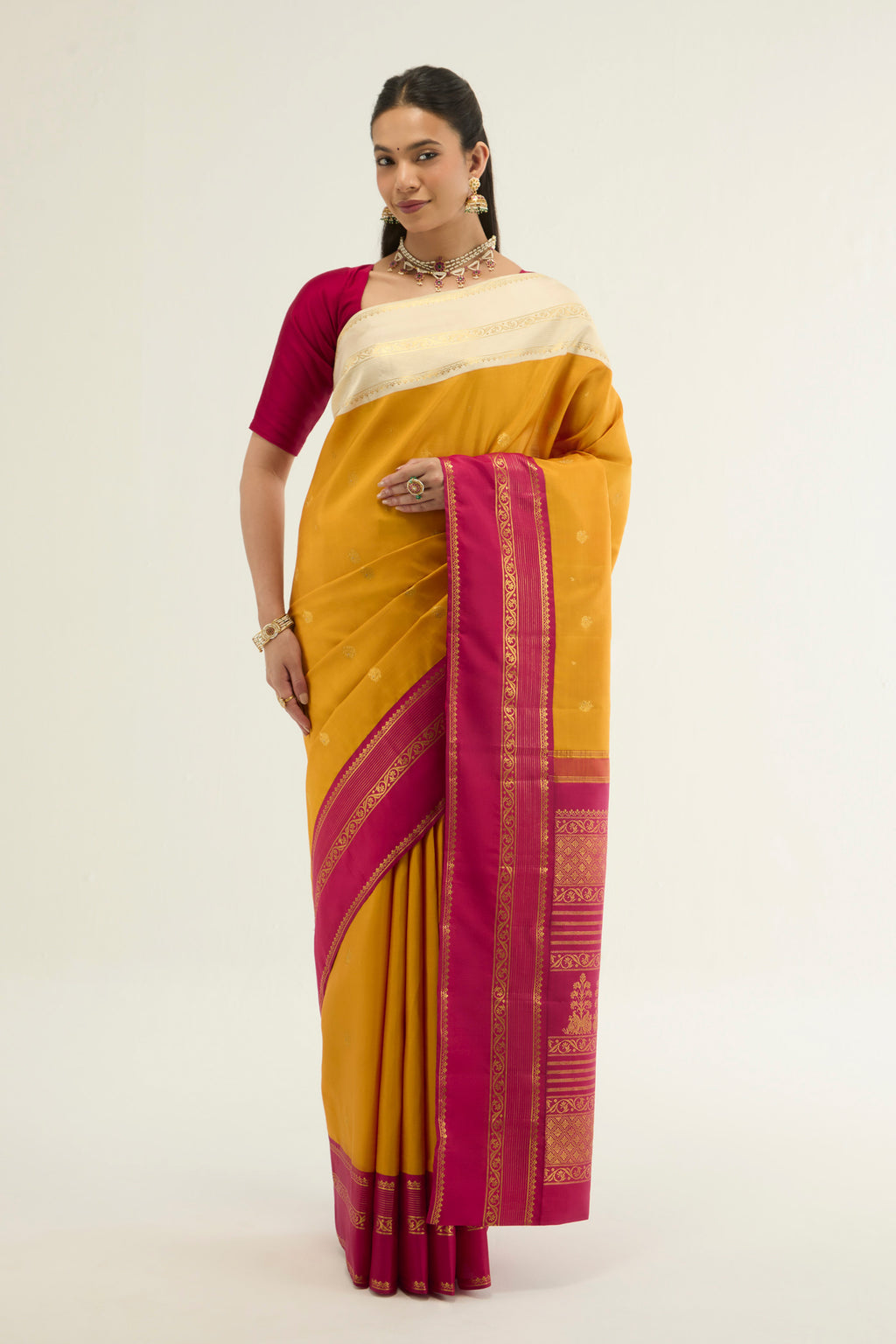 Yellow Kanchipuram Silk Saree with Zari Butta on the body and Ganga Jamuna Border displayed on a mannequin