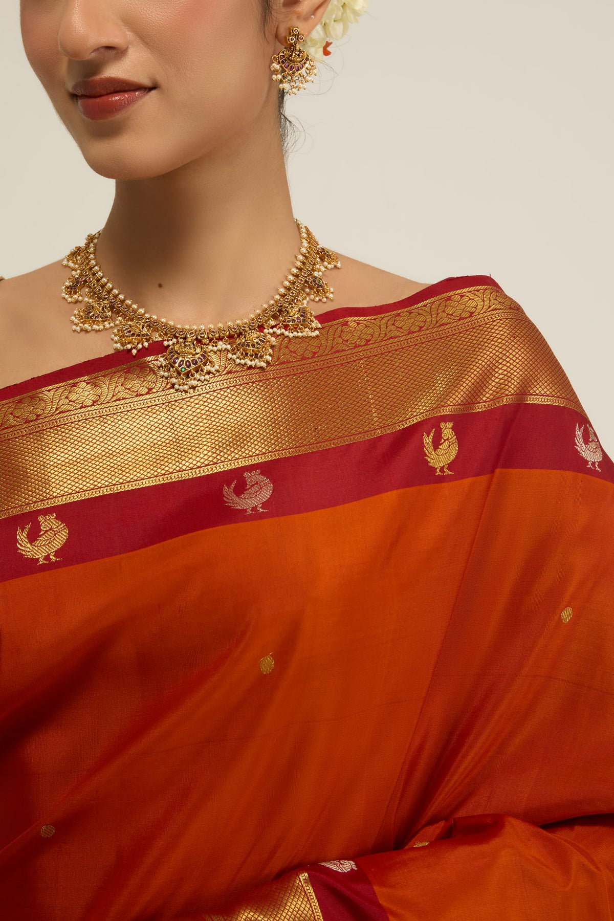 Border image of Orange Kanchipuram Silk Saree with Zari Butta on the body and Zari Border