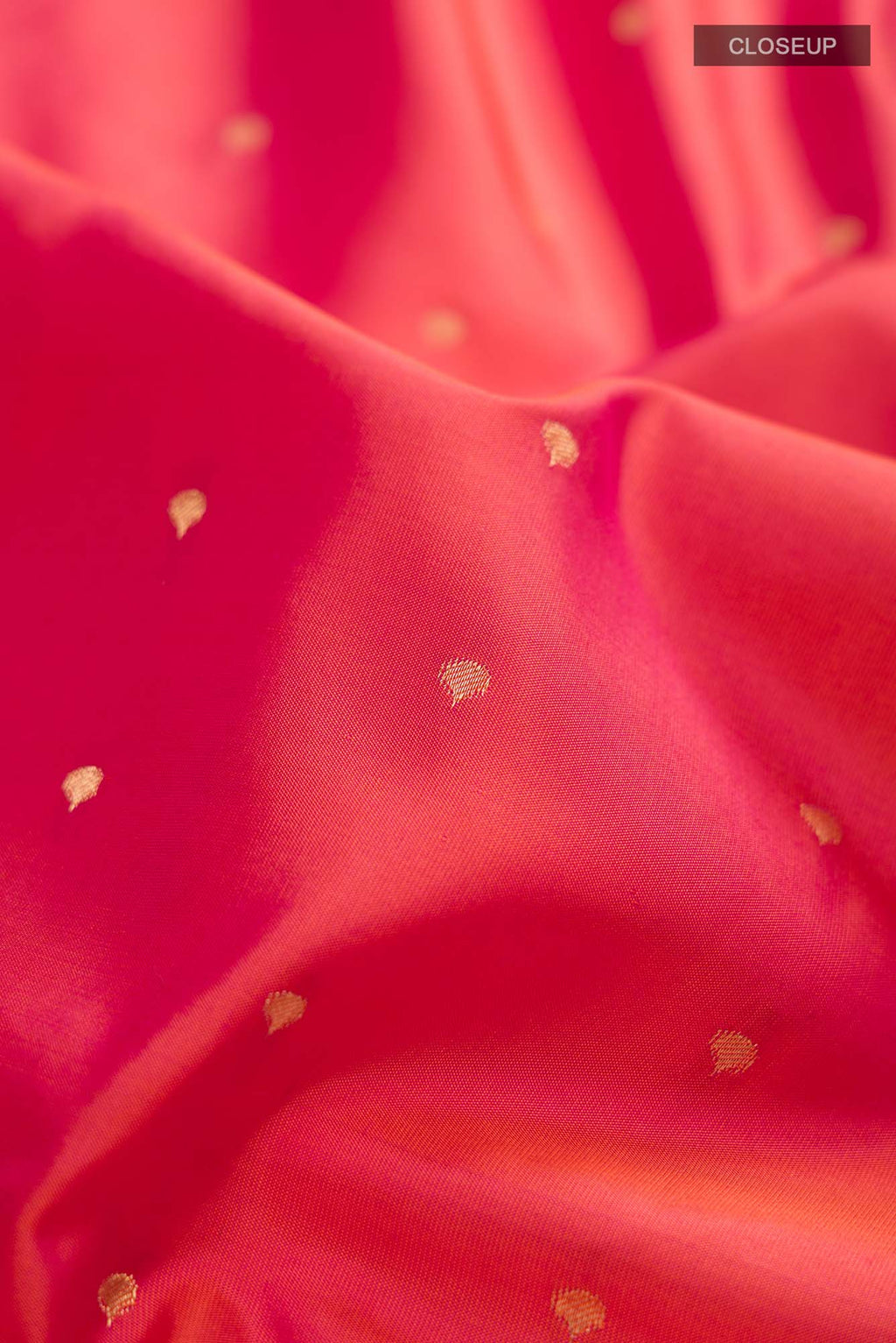 Close up of Maroon Banarasi Raw Silk Saree with Checked design on the body and Zari Border.  displaying folds