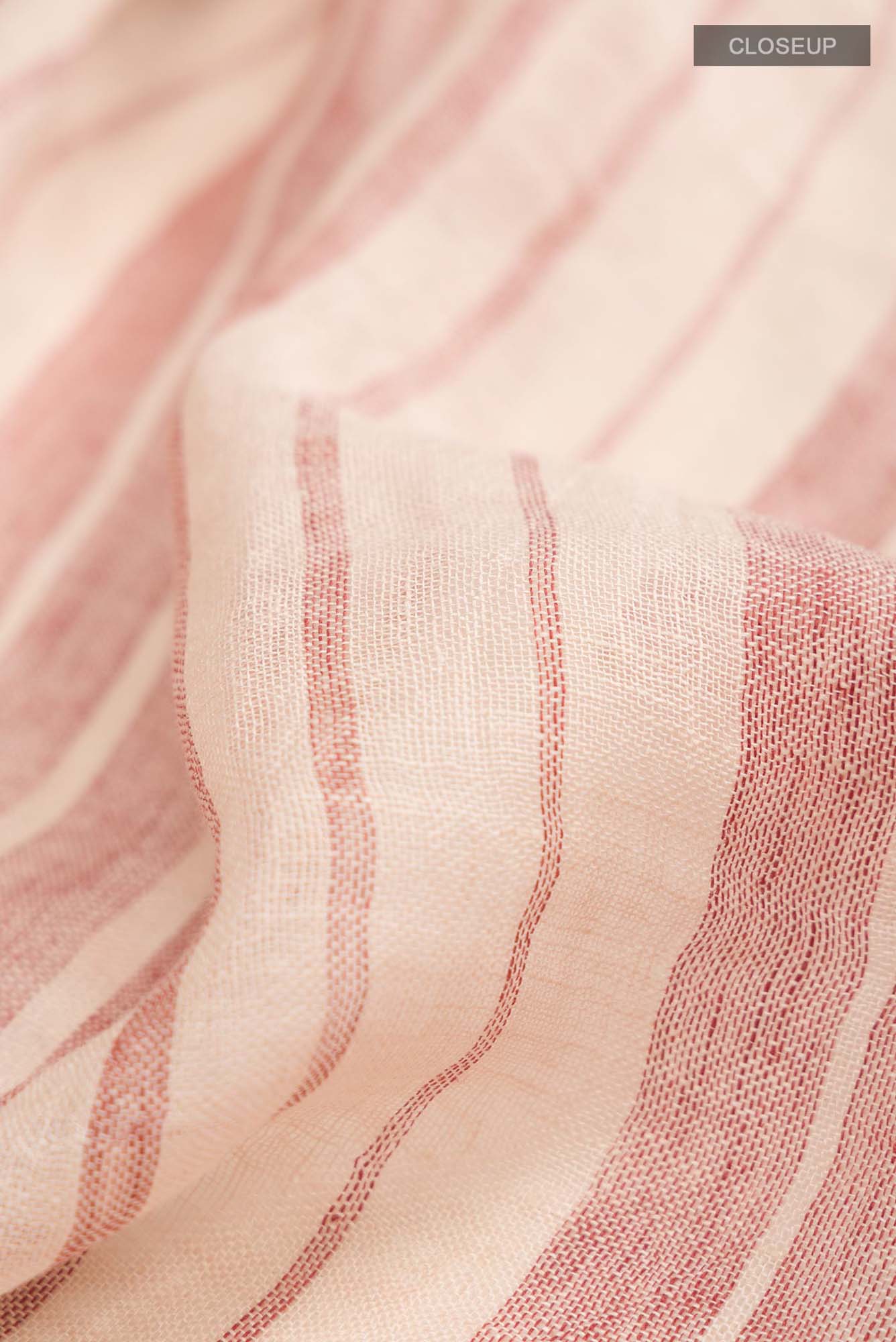 Close up of Cream Linen Saree with Stripes on the body and Checks Border.  displaying folds
