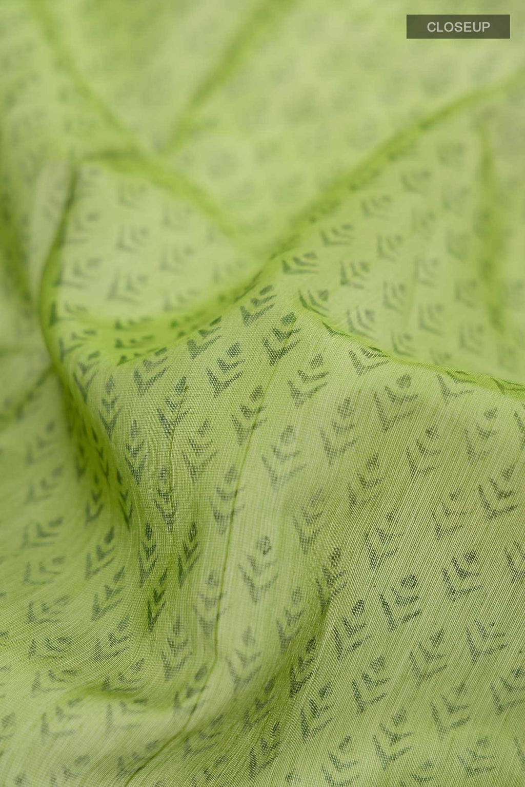 Close up of Green Maheshwari Silk Cotton Saree with Printed design on the body and Zari Border.  displaying folds