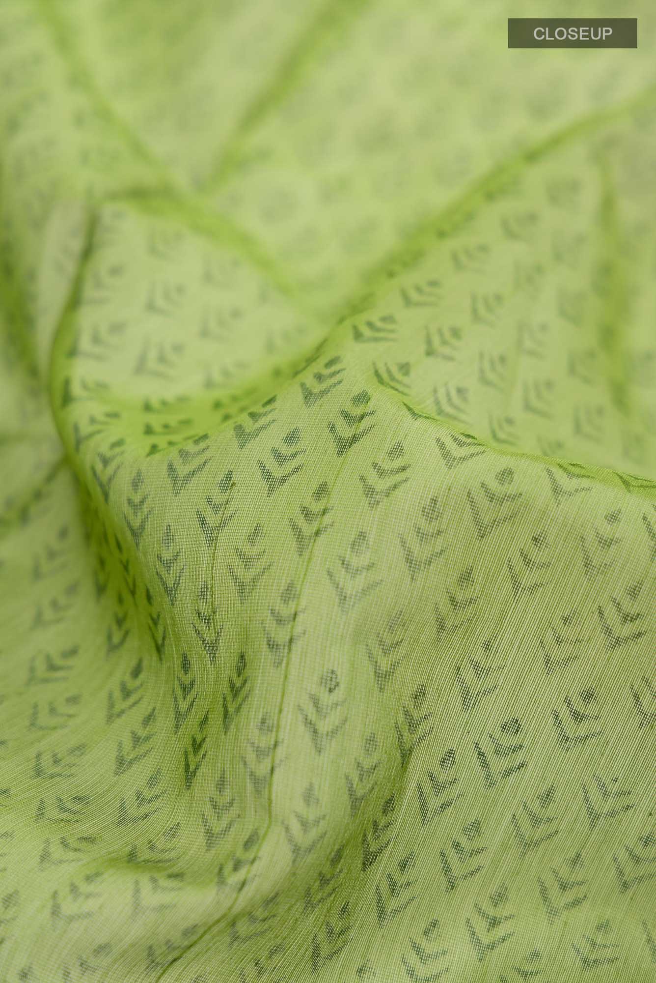 Close up of Green Maheshwari Silk Cotton Saree with Printed design on the body and Zari Border.  displaying folds