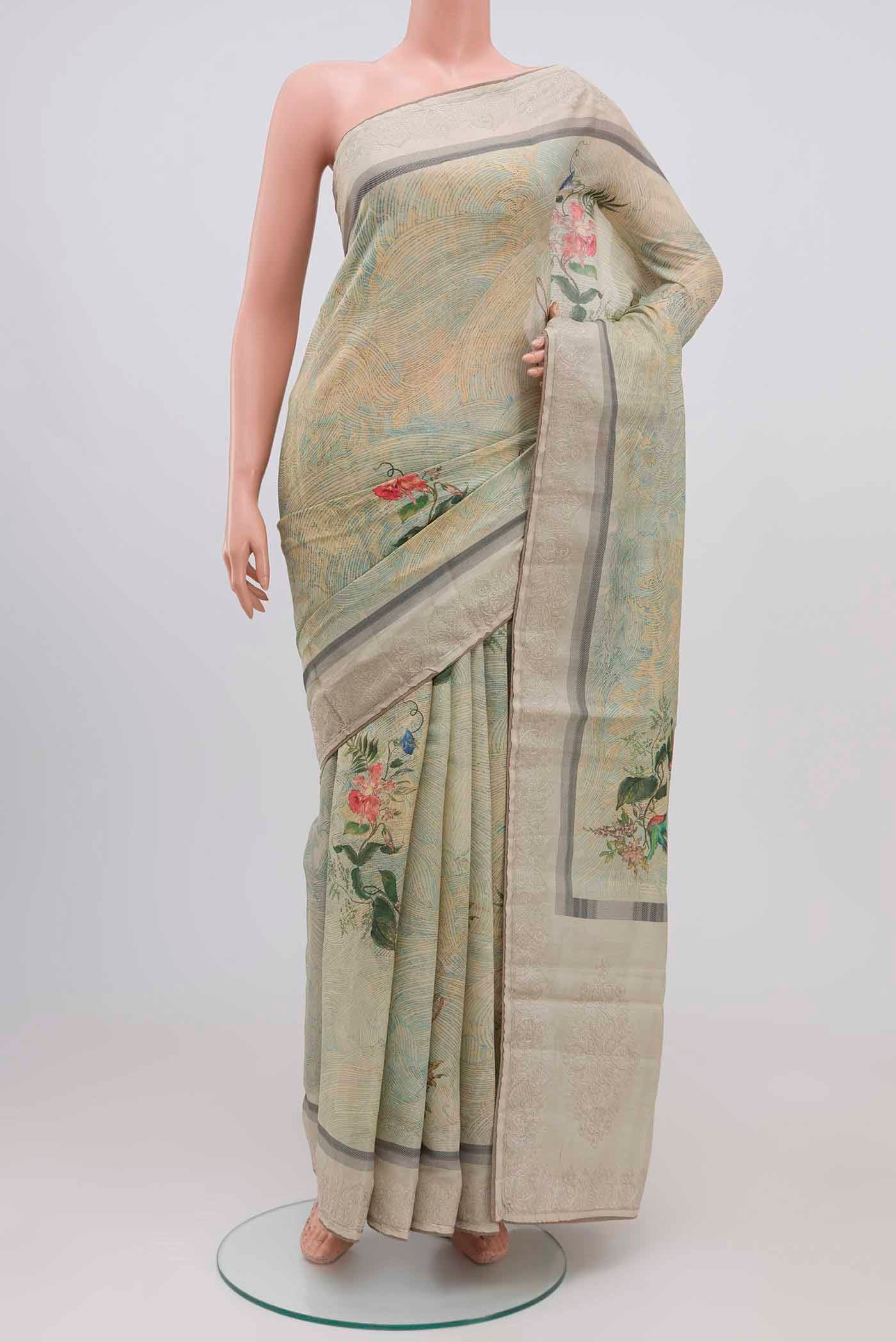 Green Blended Tussar Silk Saree with Printed design on the body and Embroidery Border.  displayed on a mannequin