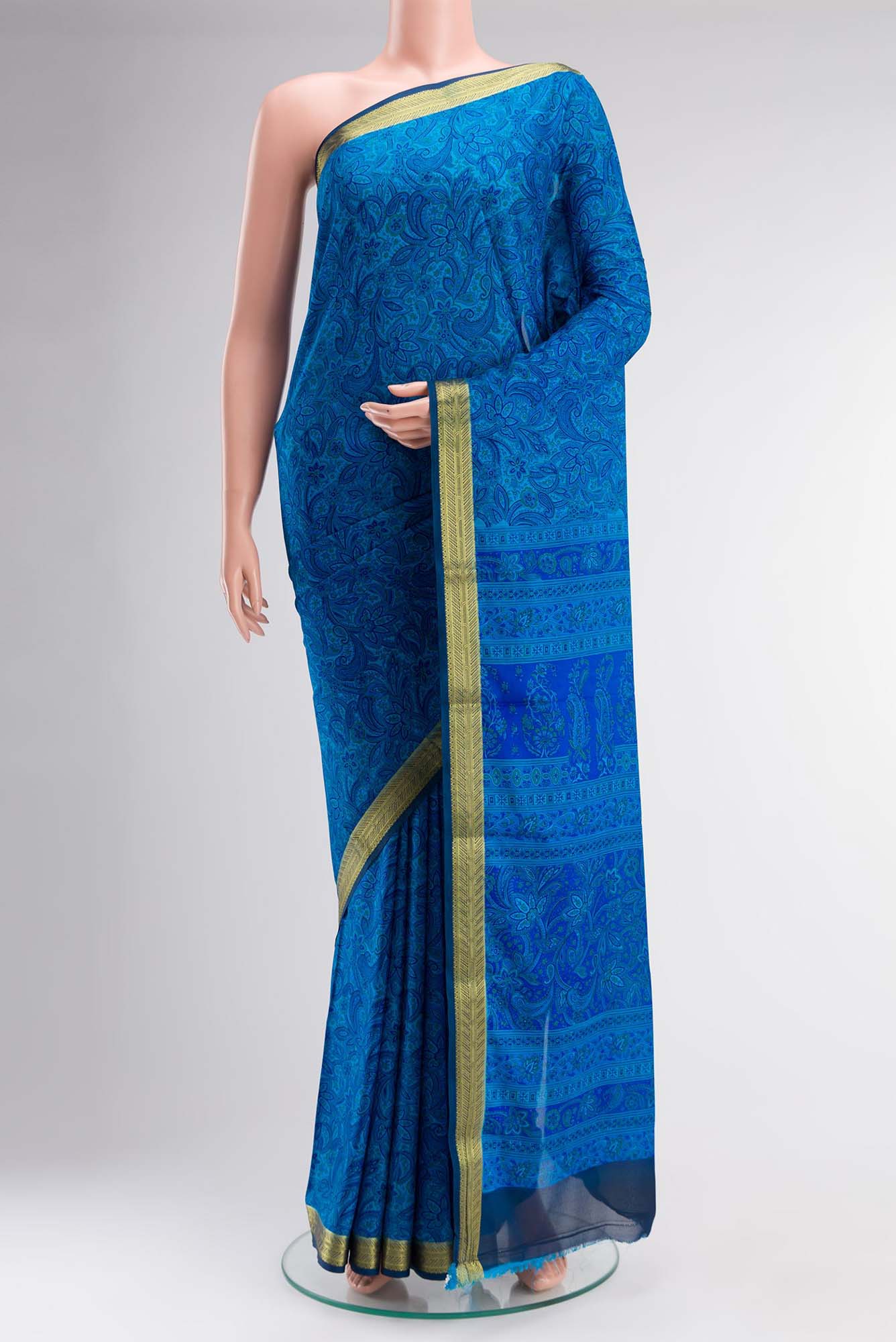 Blue Blended Crepe Saree with Floral Print on the body and Zari Border.  displayed on a mannequin