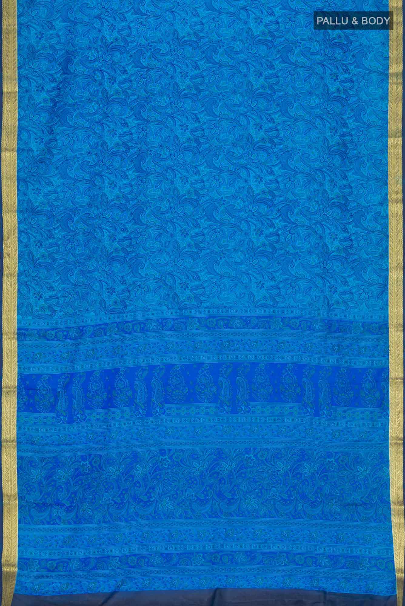 Flat view of Blue Blended Crepe Saree with Floral Print on the body and Zari Border. 
