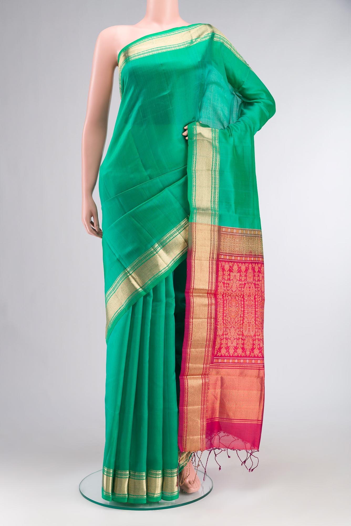 Green Raw Silk Saree with Plain Body and Zari Border.  displayed on a mannequin