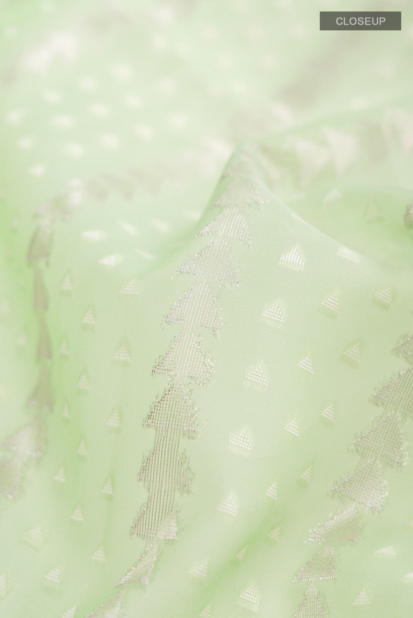 Close up of Green Blended Kora Cotton Saree with Zari Butta on the body and Zari Border.  displaying folds