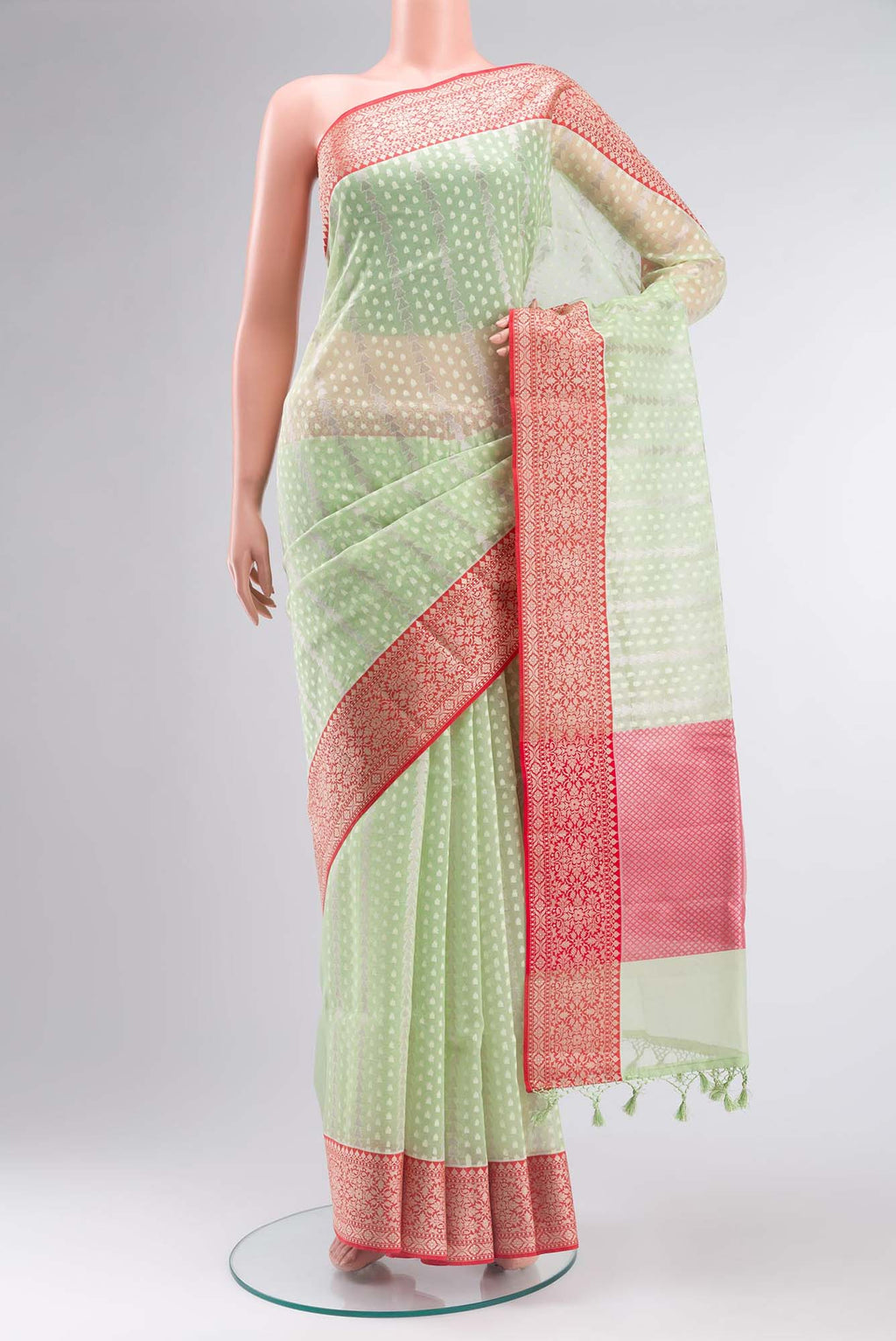 Green Blended Kora Cotton Saree with Zari Butta on the body and Zari Border.  displayed on a mannequin